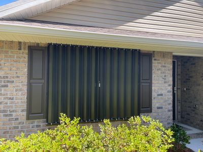 Bronze Accordions on brick home