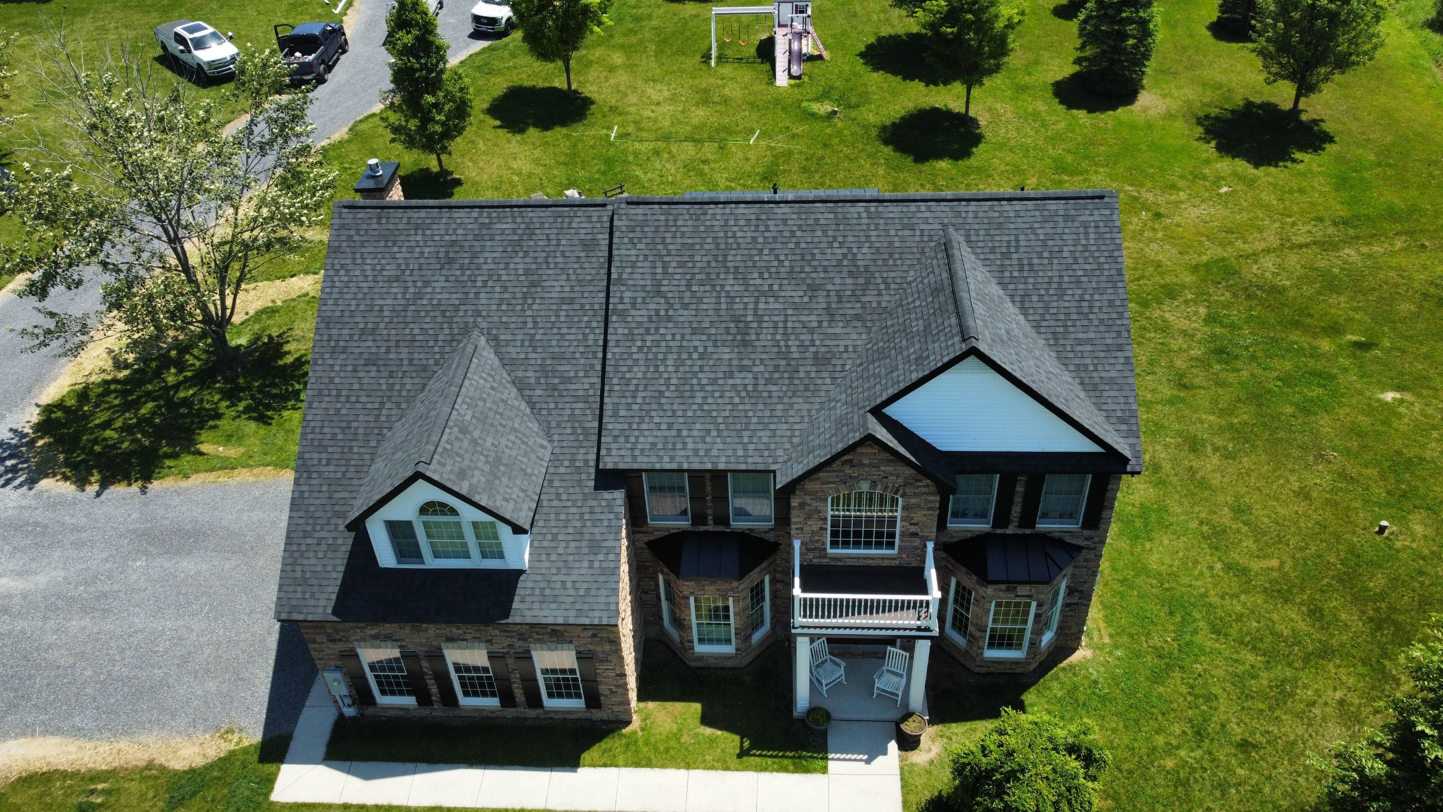 Roof Damage using Certainteed Lifetime Roofing System- Moire Black Landmark Pro shingkes with shadow ridge caps. by BulletpROOF Exteriors