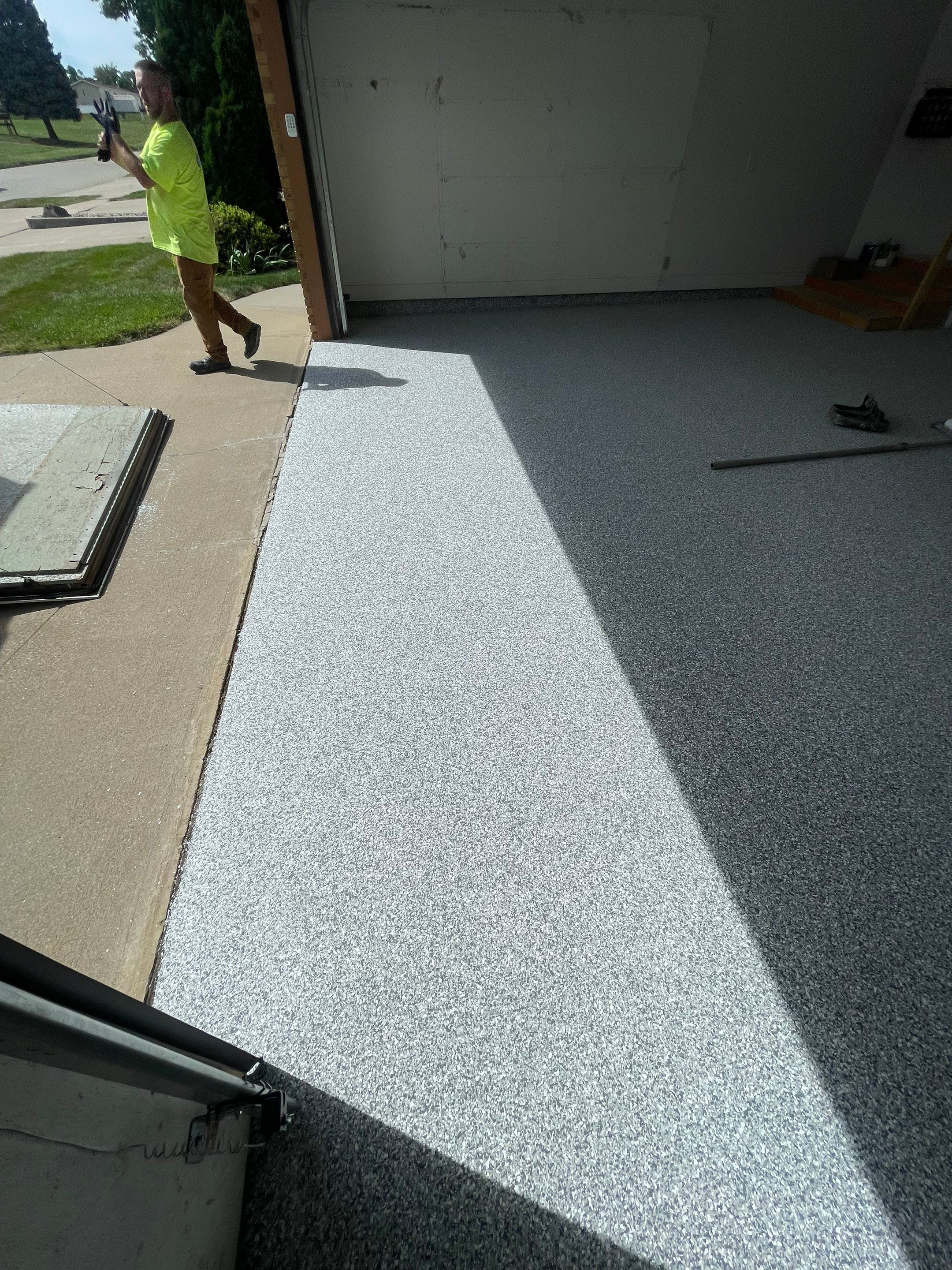 Grey Speckled Concrete Coating for Residential Garage in Yankton by Select Painting, Coatings & Garage Cabinets