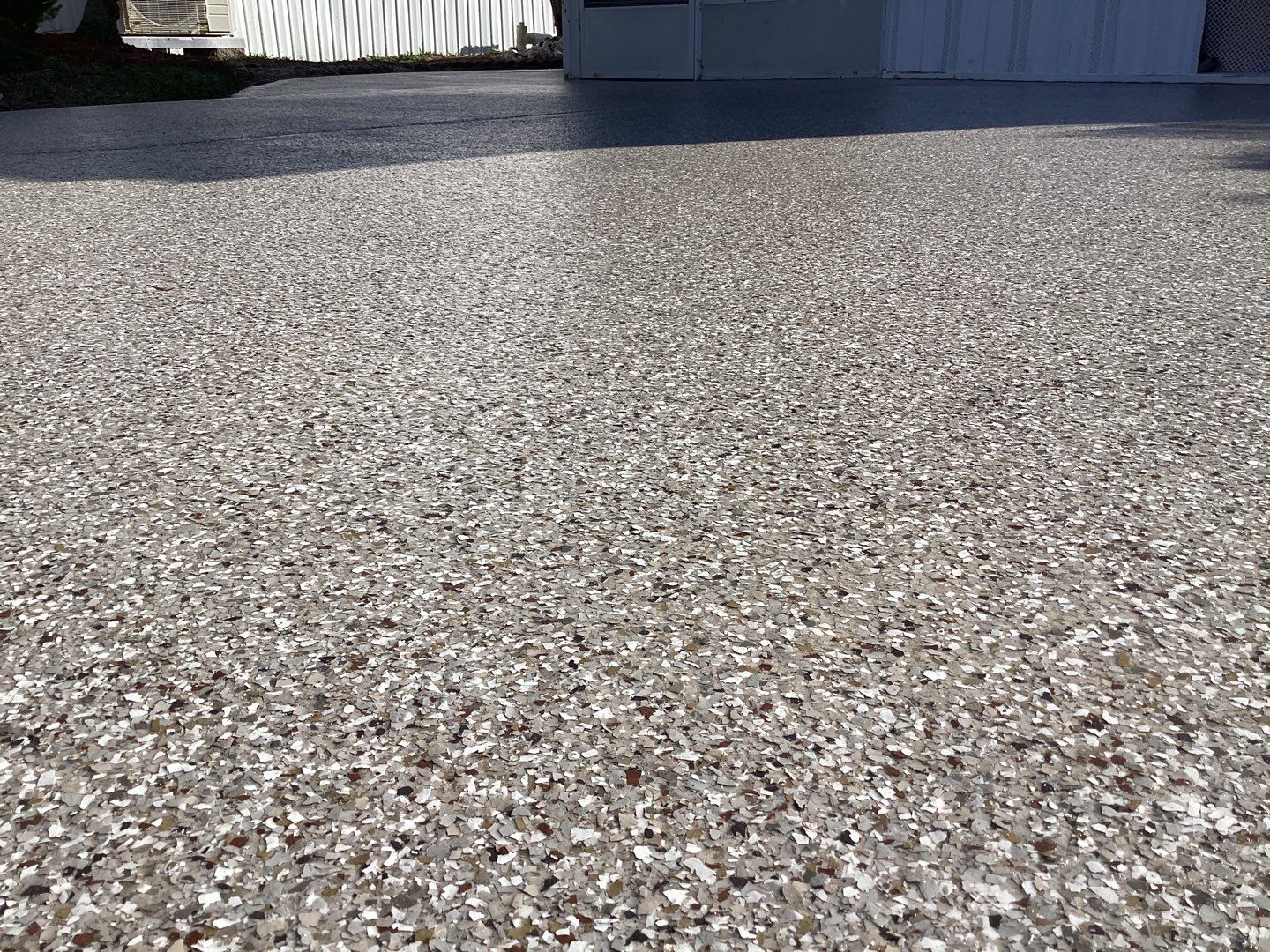 Driveway using Pebble Beach by Amvet concrete coatings llc