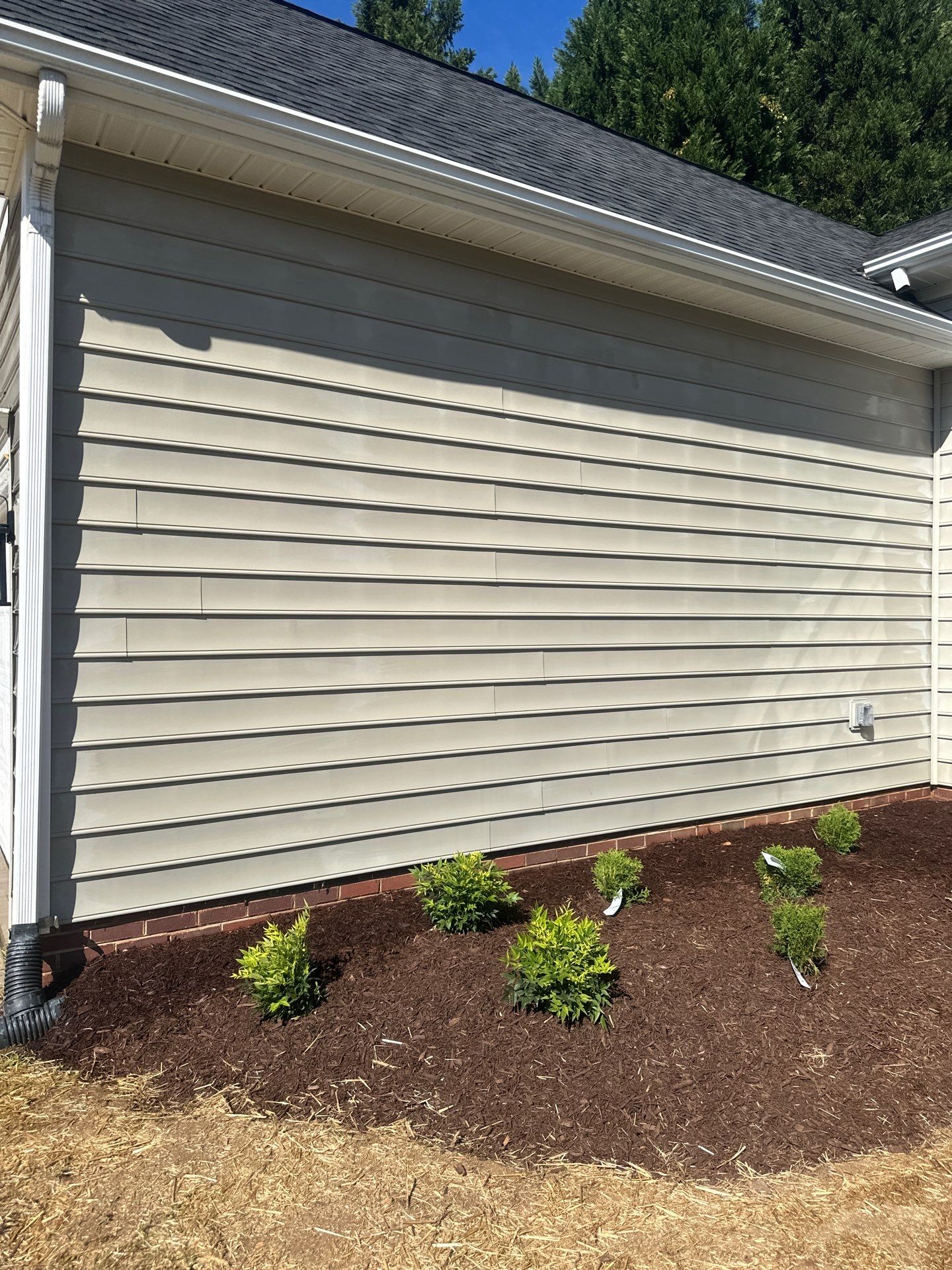 the service being done is cleaning the exterior siding of a house to remove dirt and grime