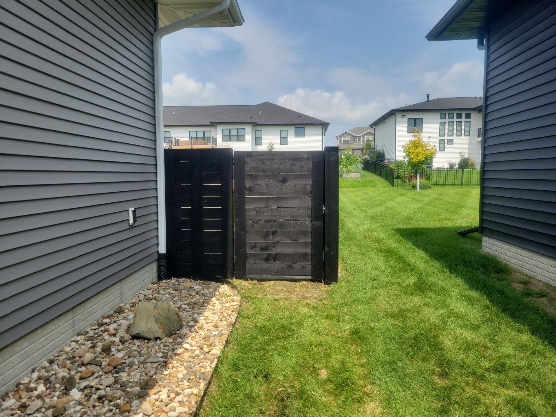 Modern Black Stained Horizontal Privacy Fence Installation in Cedar by Perfect Picket Fence and Stain