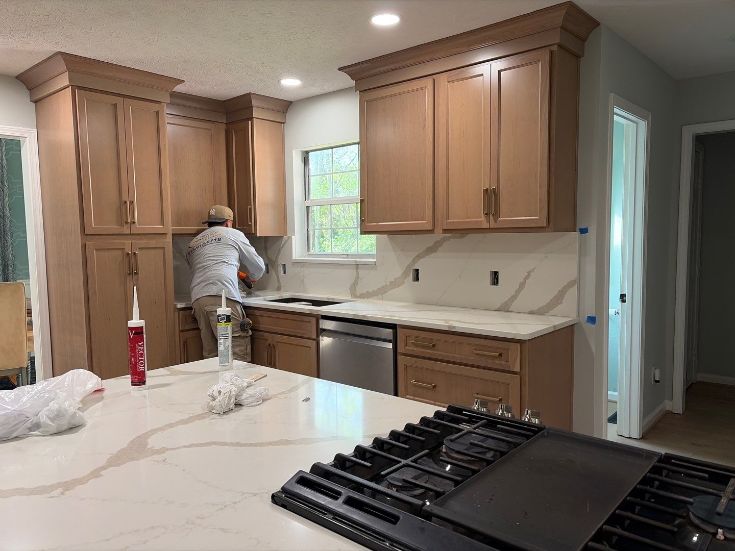 Modern Kitchen Remodel Featuring Quartz Backsplash, under cabinet lighintg, and a coffee bar in Mt. Juliet Tennessee by DeRo Renovations,LLC