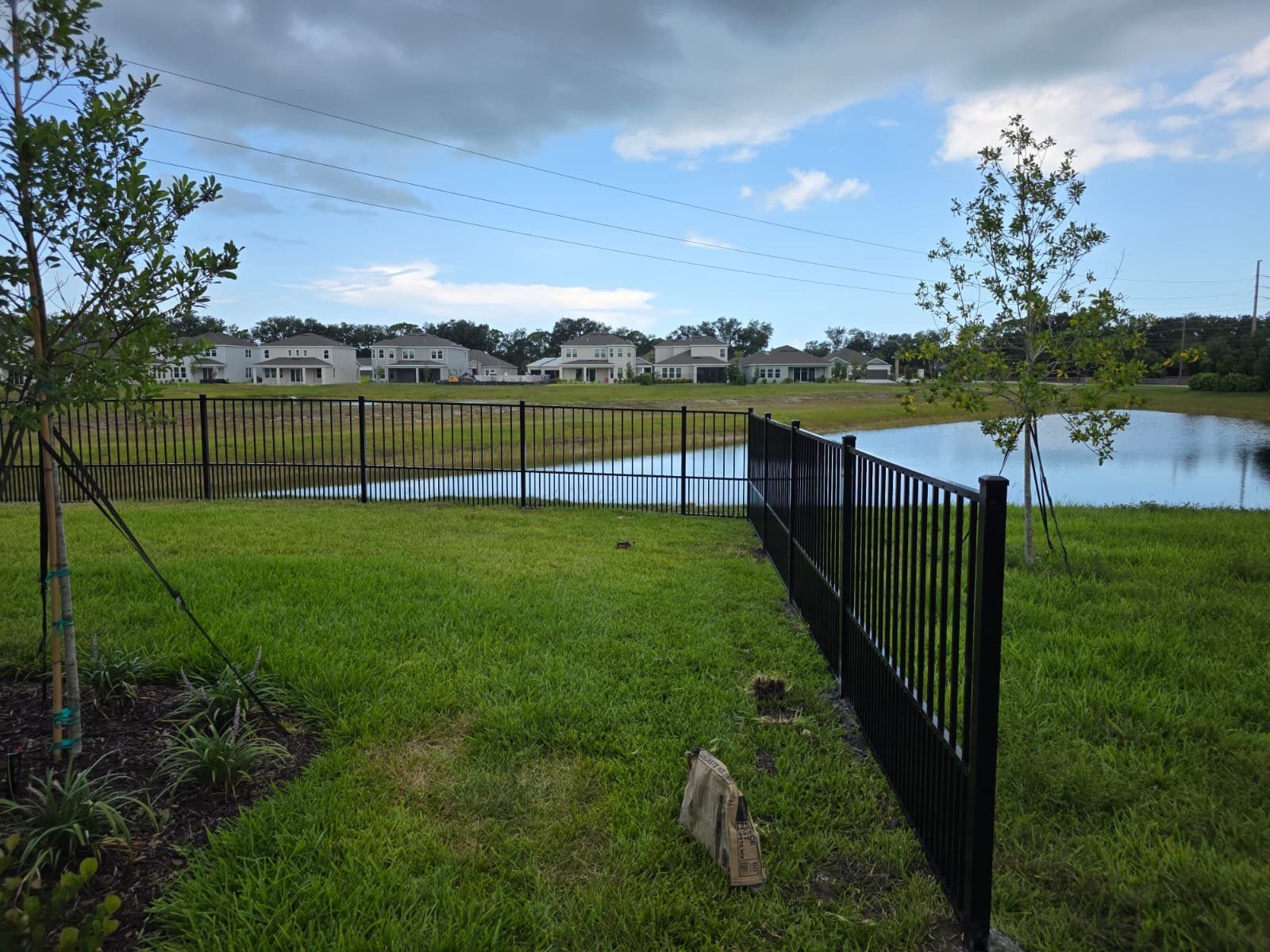 Black Aluminum Puppy Picket Fence Installation in Nokomis by True Fence LLC
