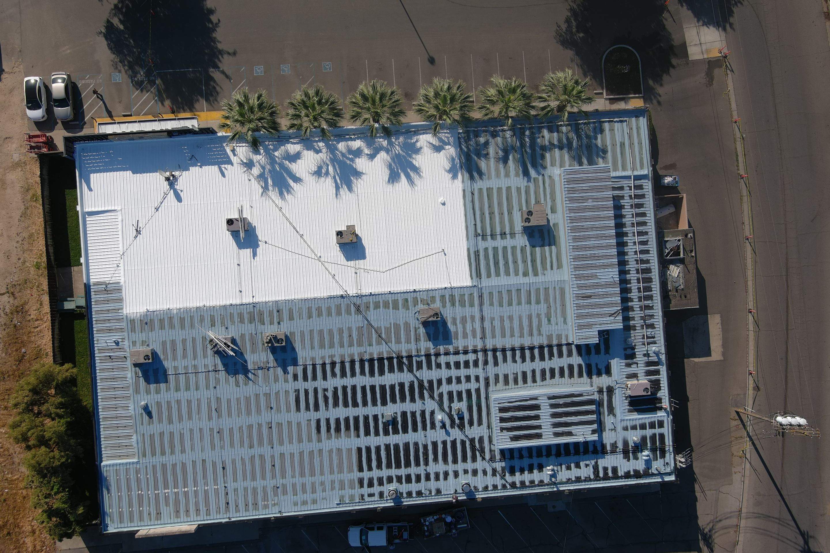 Metal roof restoration on commercial roof using Conklin Benchmark/ PUMA XL acrylic coatings over metal and foam by Straight Edge Roofing Inc