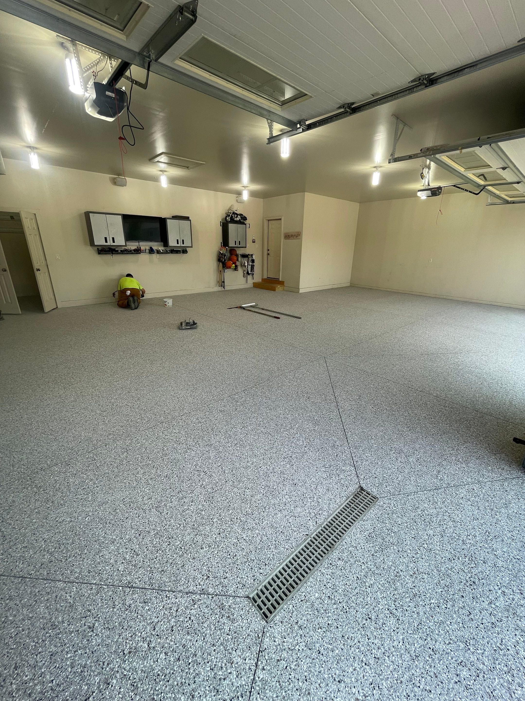 Coyote Flake Garage Floor Coating in Sioux Falls with Trench Drain by Select Painting, Coatings & Garage Cabinets