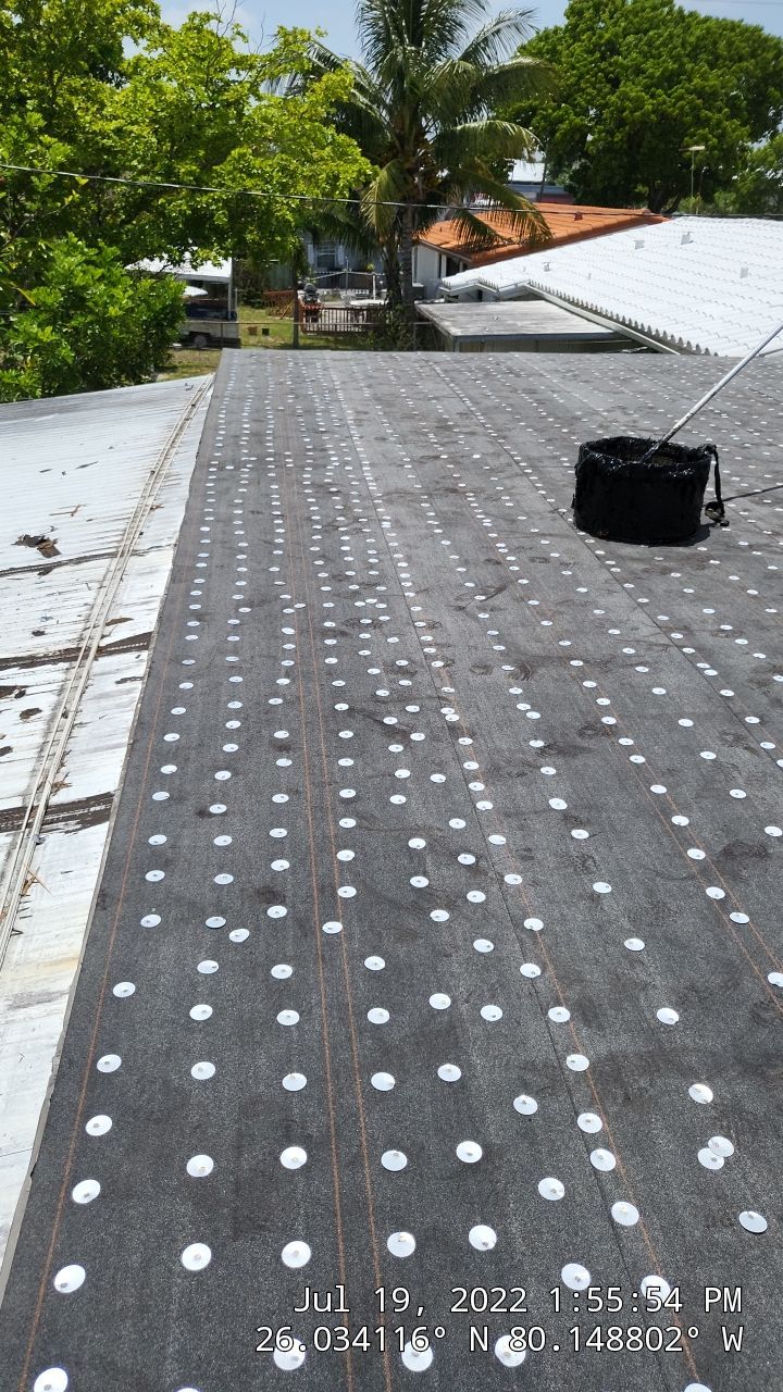 Standing Seam Metal & Flat Re-Roof using 1.5" Nail Strip 24ga Black Matte Kynar Coated Standing Seam Metal Panels by Morton Roofing, Inc.
