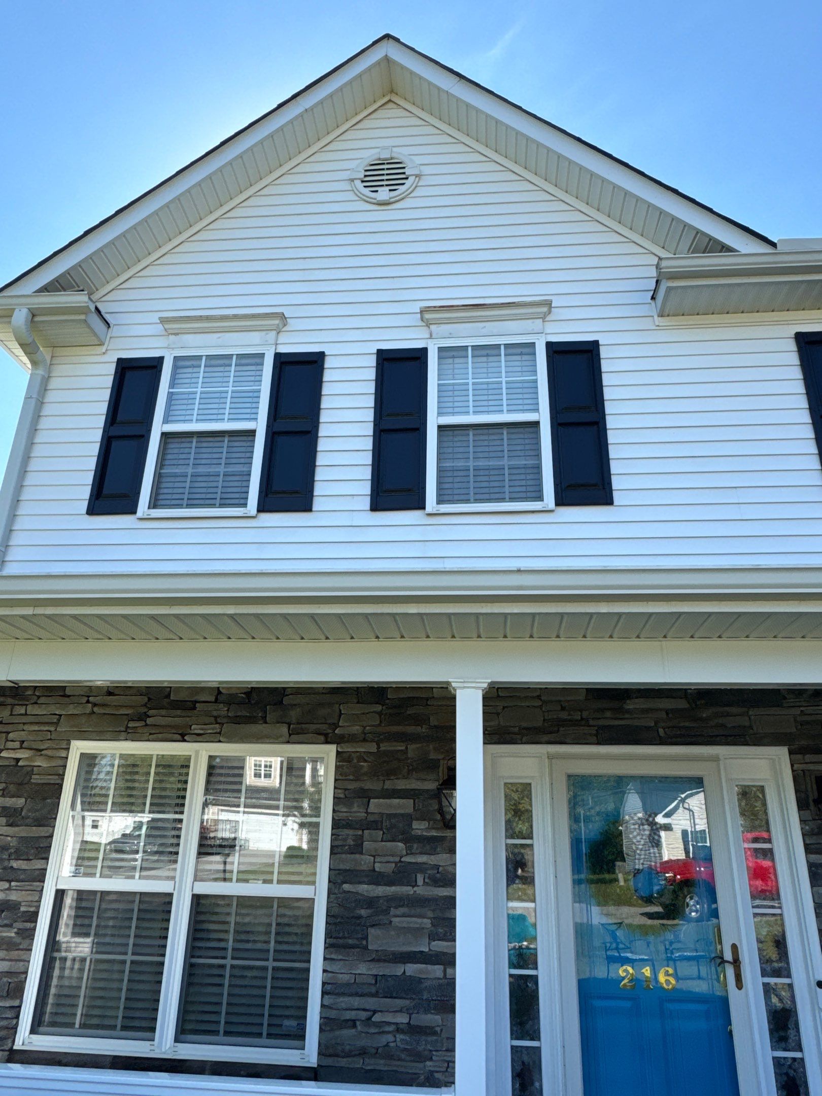 the service being done is cleaning the siding and stone facade of the house to remove dirt and grime