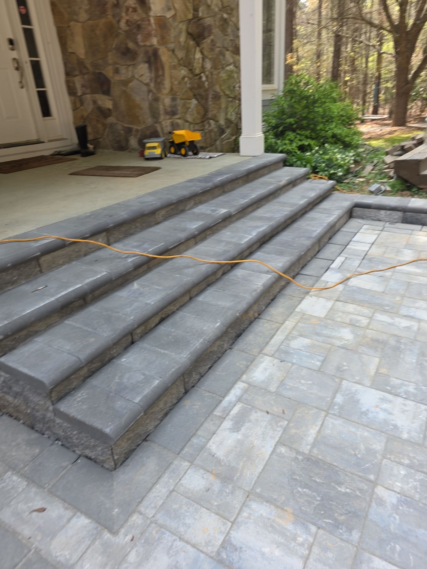 Pittsboro Outdoor Living Transformation – Retaining Wall, Paver Patio & Elevated Deck by Elite Remodeling and Design LLC