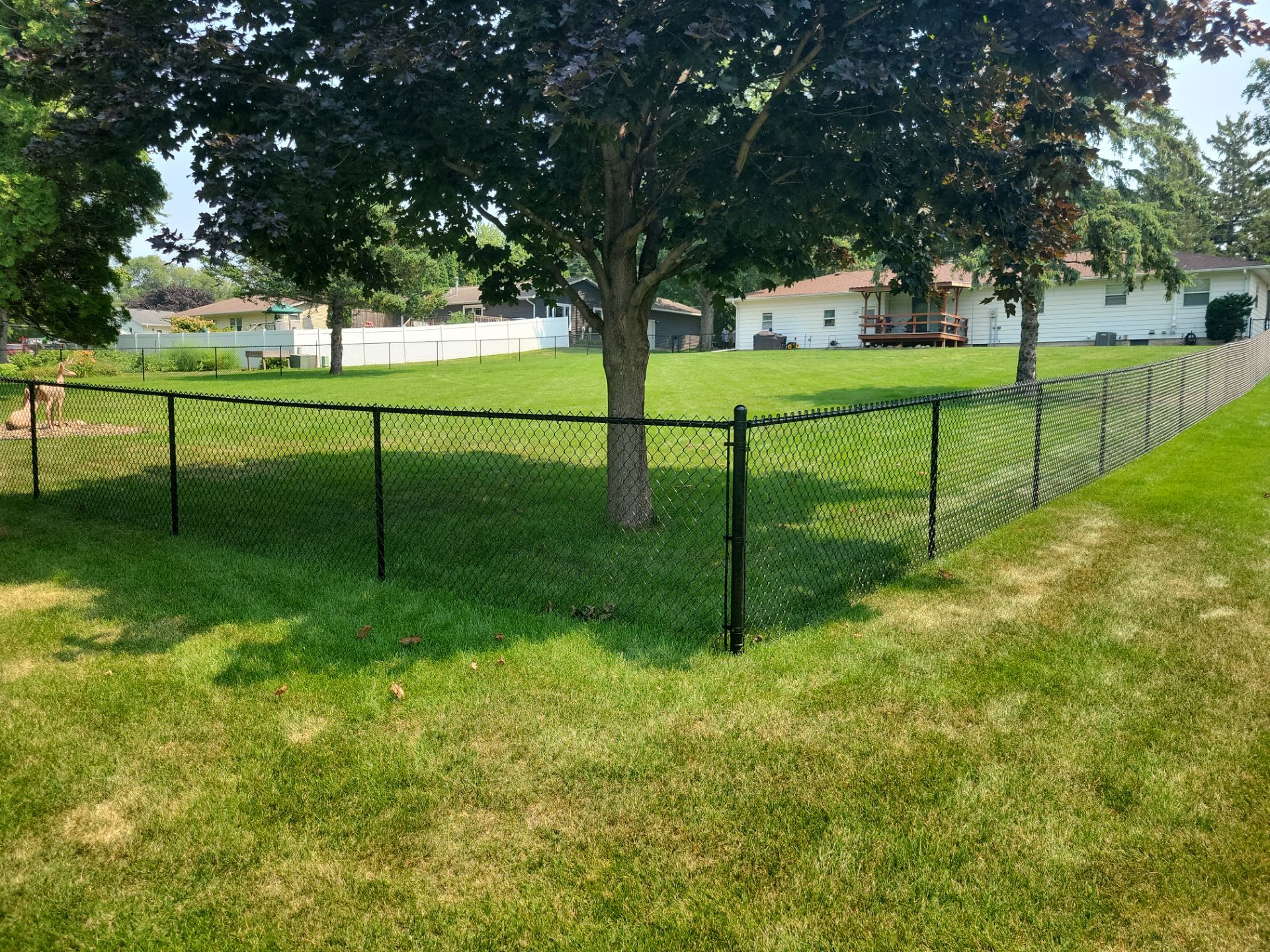 Black Vinyl-Coated Chain Link Fence Installation in New Hampton by Perfect Picket Fence and Stain
