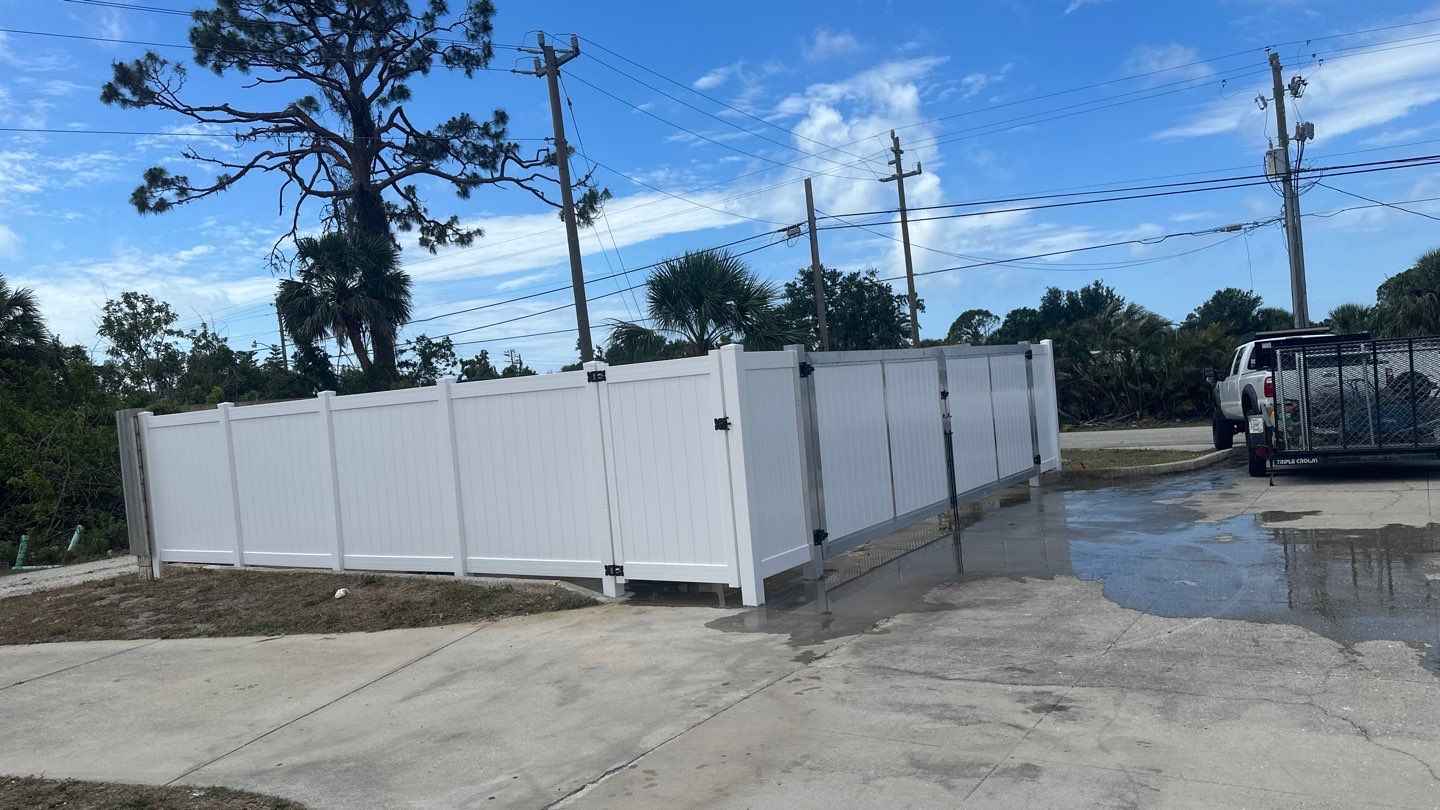 Commercial Chainlink and Vinyl Fence With Aluminum Framed Gates On Dumpster Enclosure by Asap fence and gates, LLC