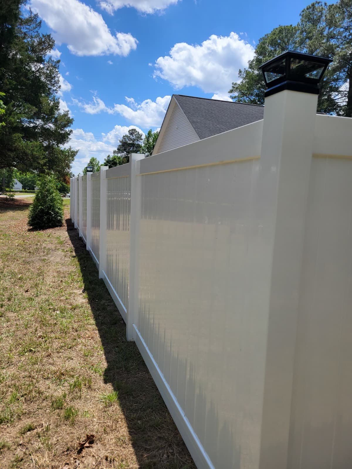 White Vinyl Privacy Fence with Solar Post Caps in Goldsboro by Superior Fence and Rail