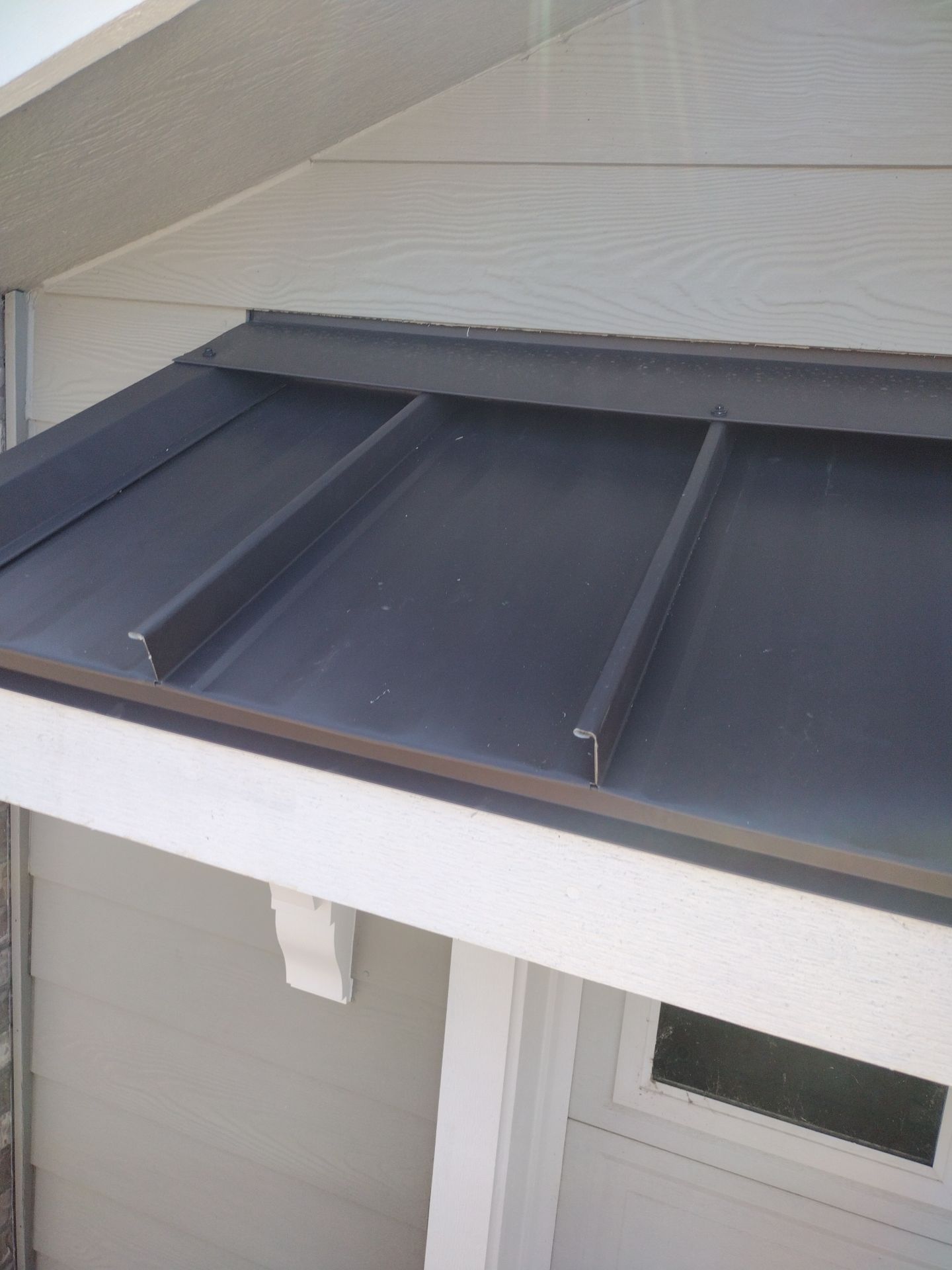 Residential Roof Replacement with Metal Accents by Orezona Building & Roofing Company, Inc.
