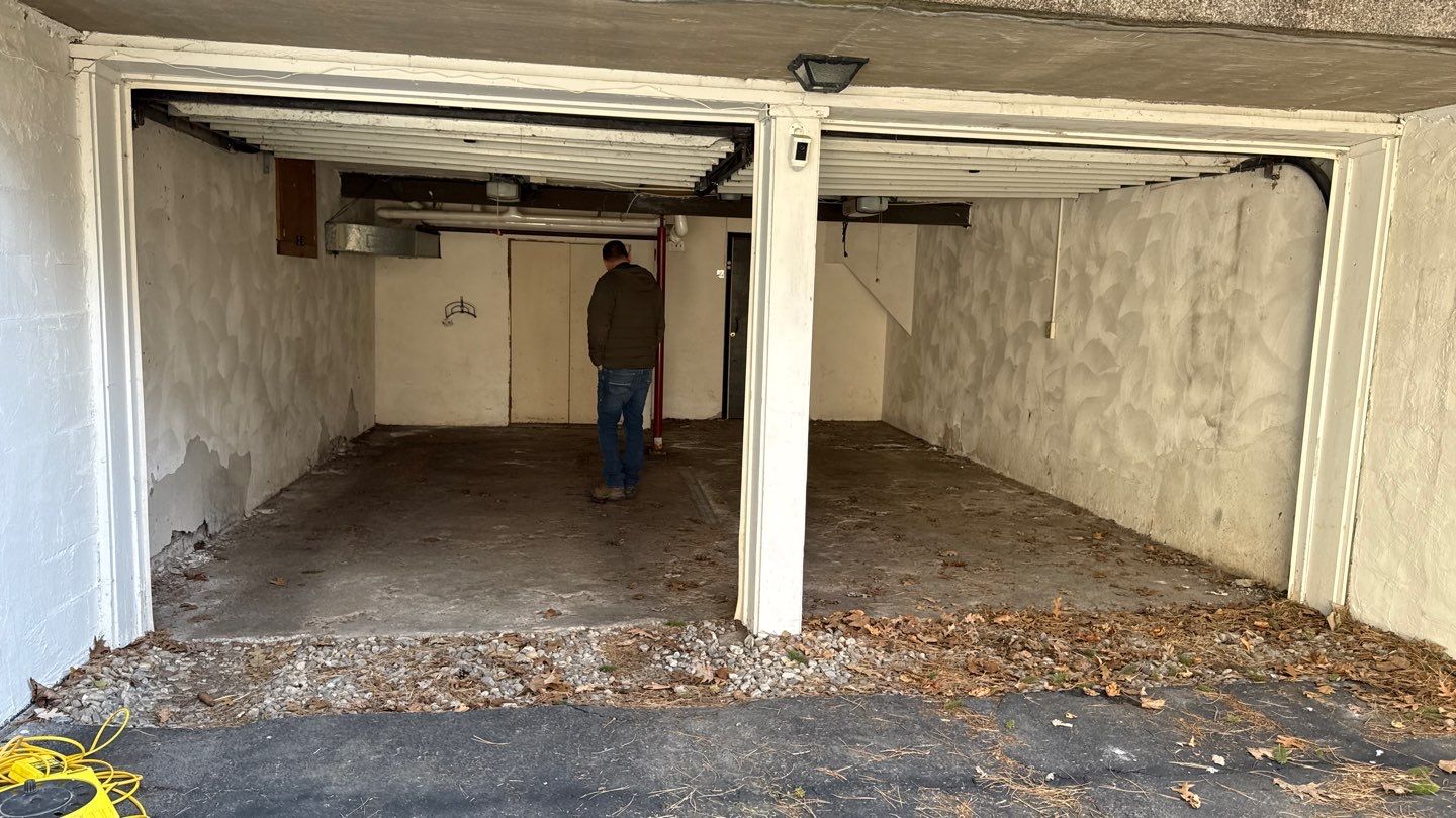 Concrete garage floor replacement with a broom finished apron and wall repair by NG Masonry & Construction LLC