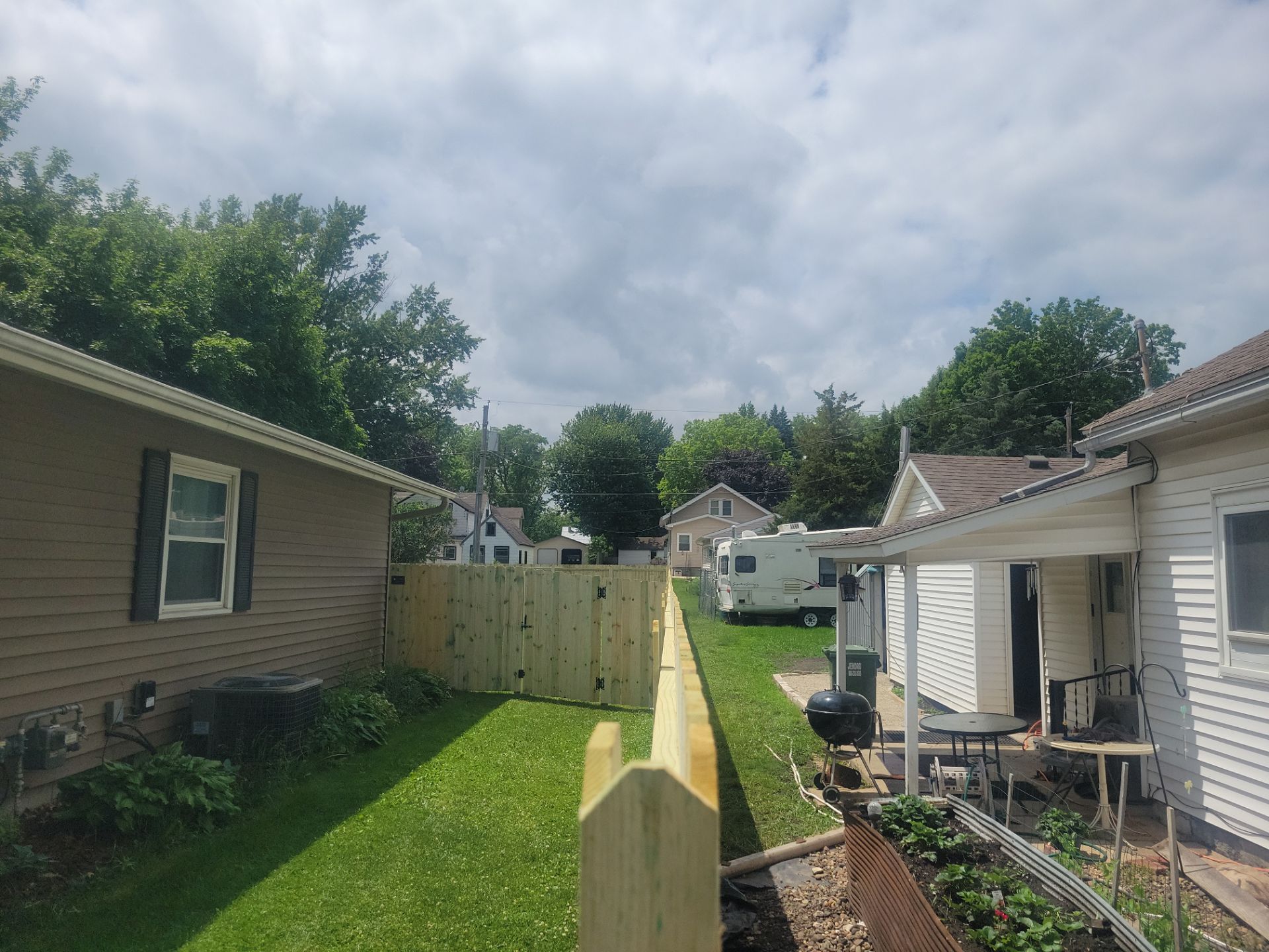 Pressure-Treated Wood Privacy Fence Installation in Charles City by Perfect Picket Fence and Stain