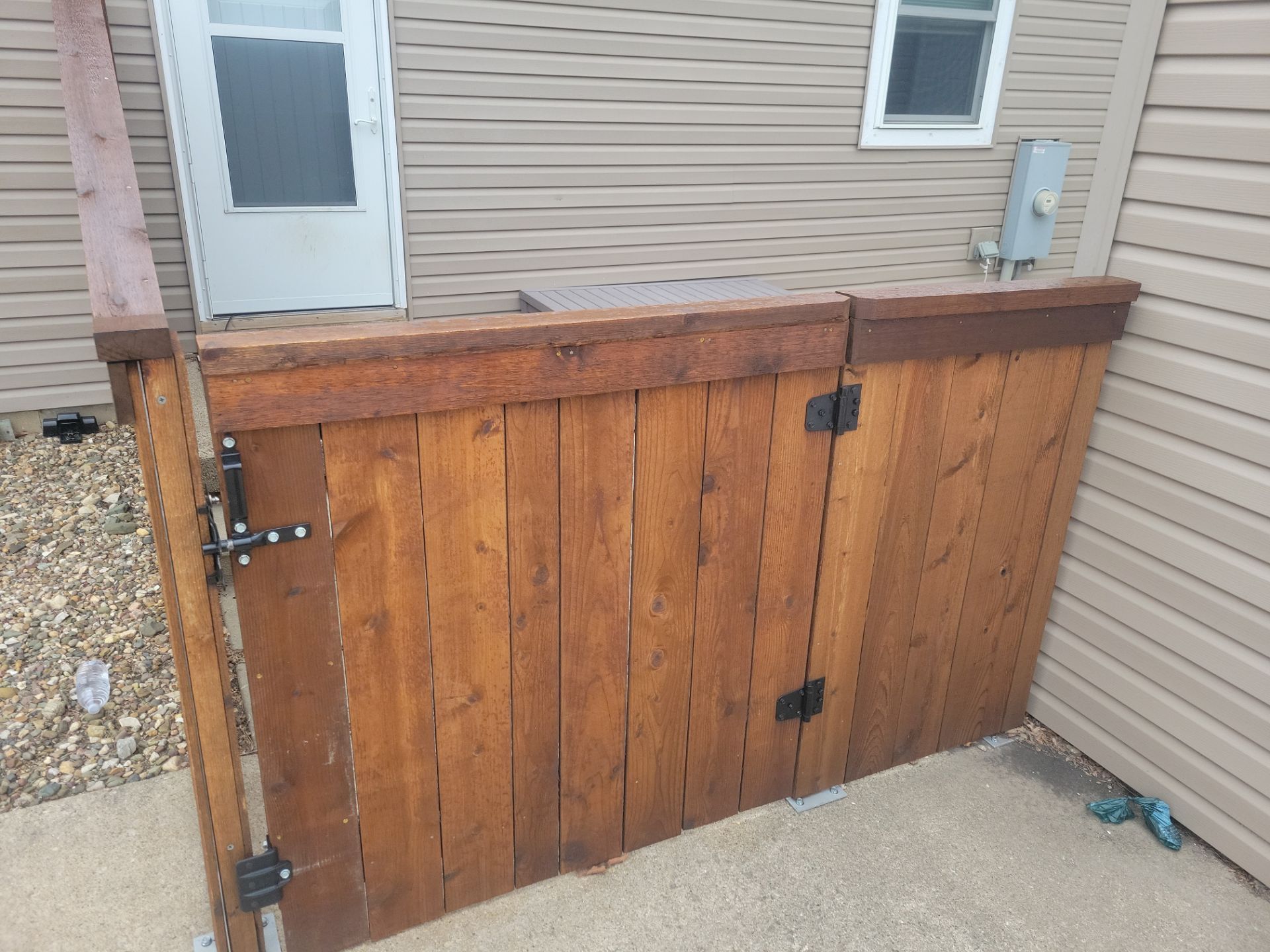 Dark Stained Cedar Privacy Fence and Custom Gates in Cedar Falls by Perfect Picket Fence and Stain