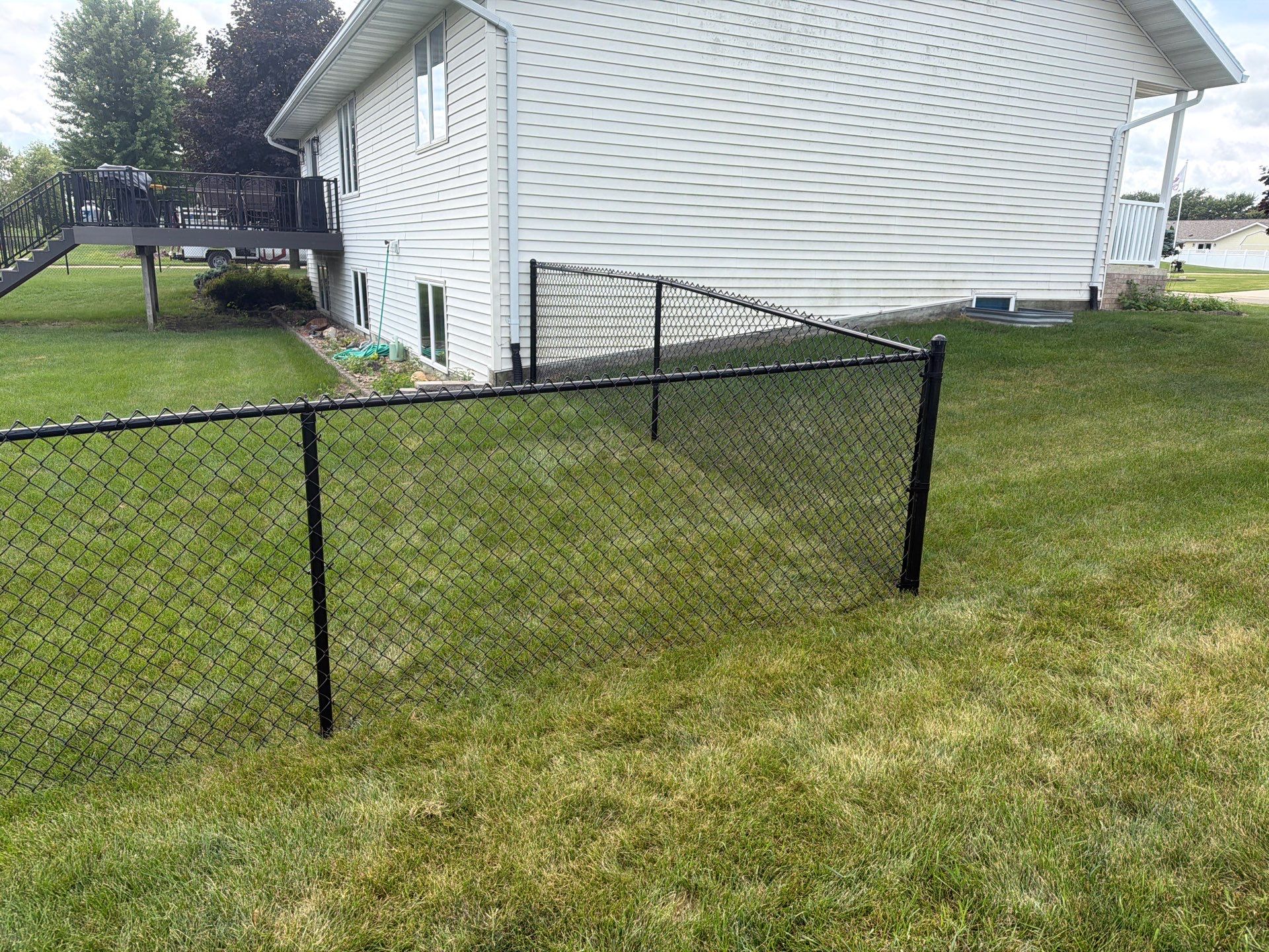 Black Vinyl-Coated Chain Link Fence Installation in Fairbank by Perfect Picket Fence and Stain