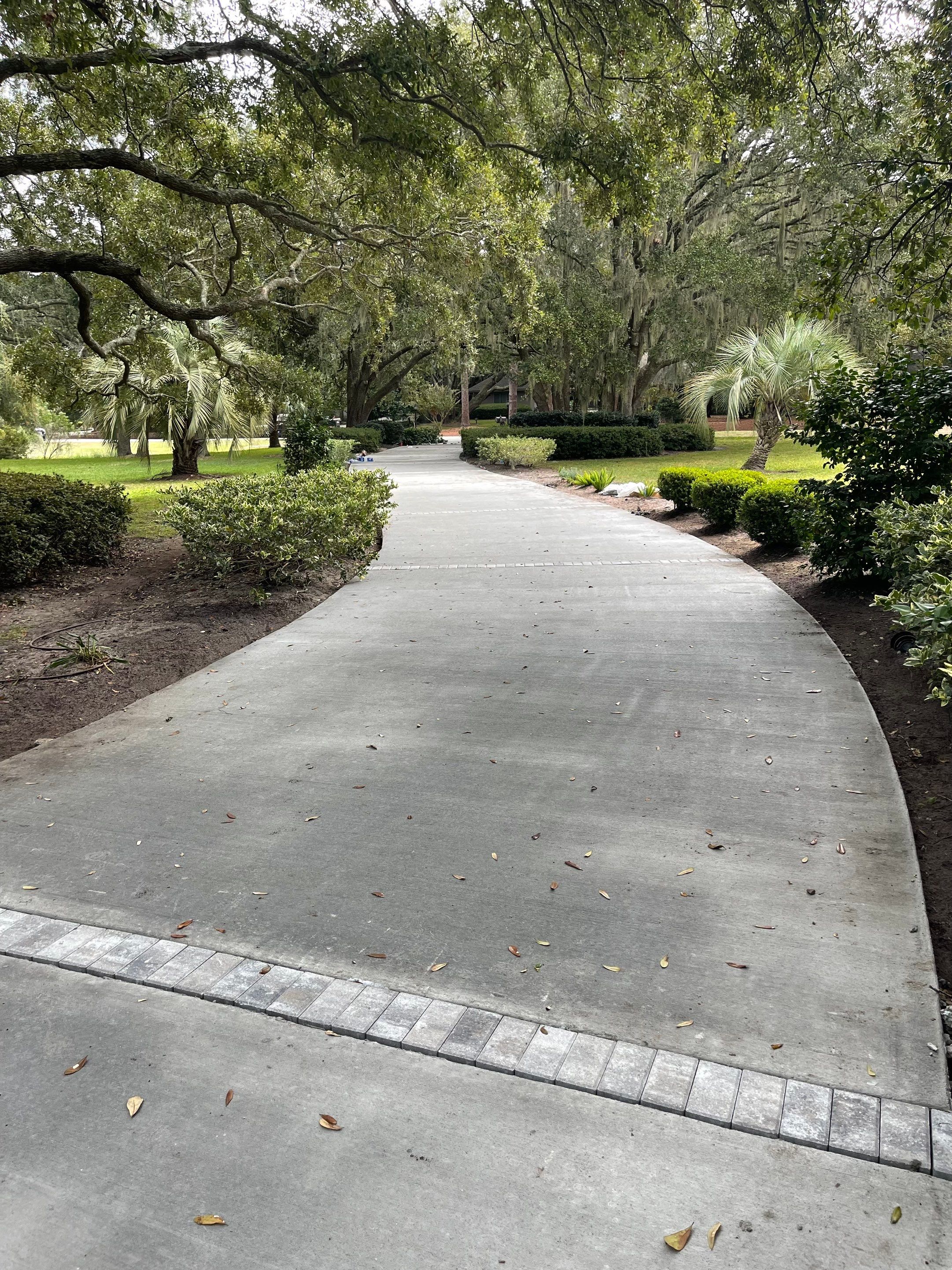 Custom Concrete Driveway with Decorative Paver Inlays in Hilton Head Island by Lowcountry Scapes, LLC
