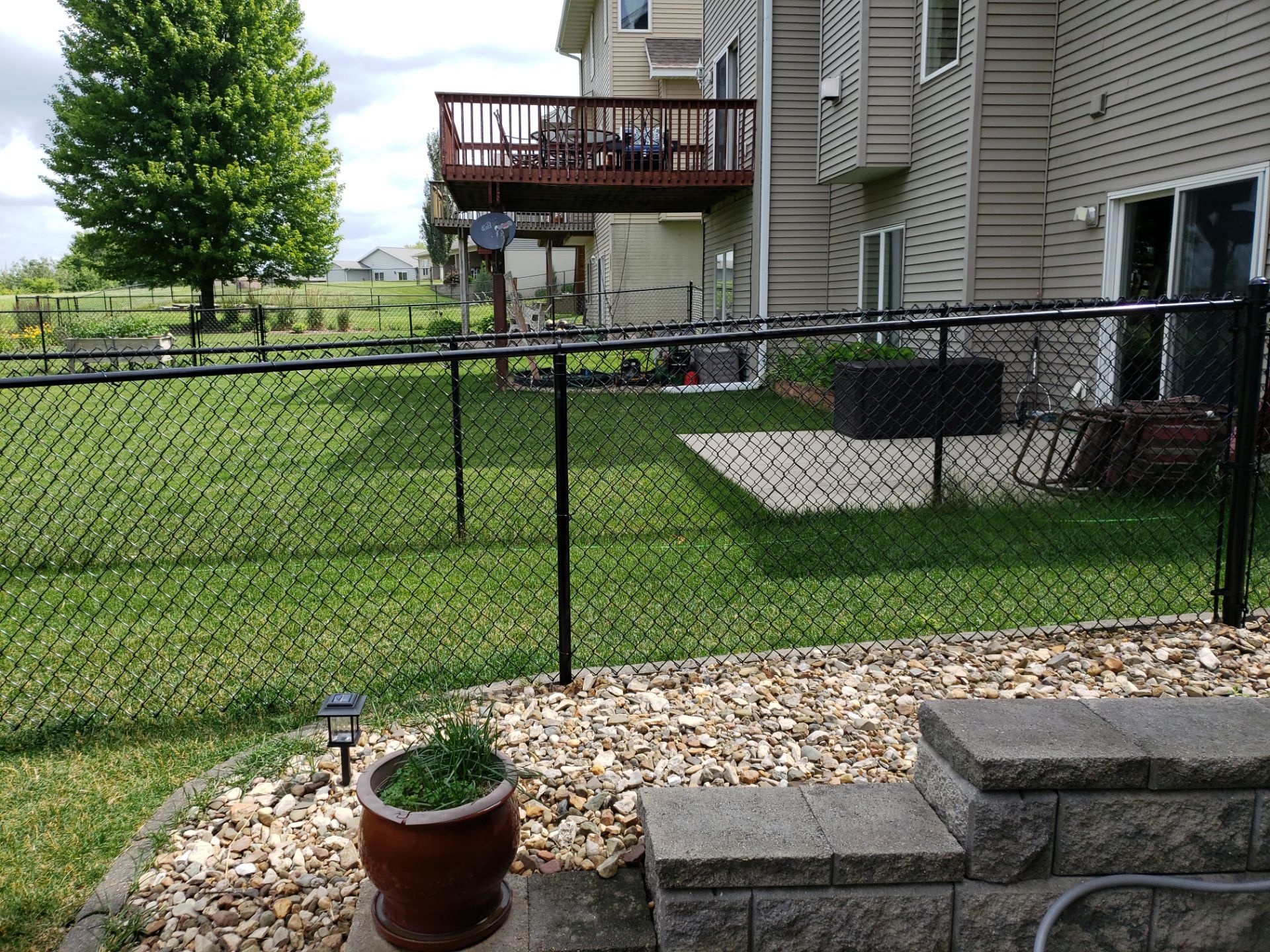 Black Vinyl Chain Link Perimeter Fence Installation in Waterloo by Perfect Picket Fence and Stain