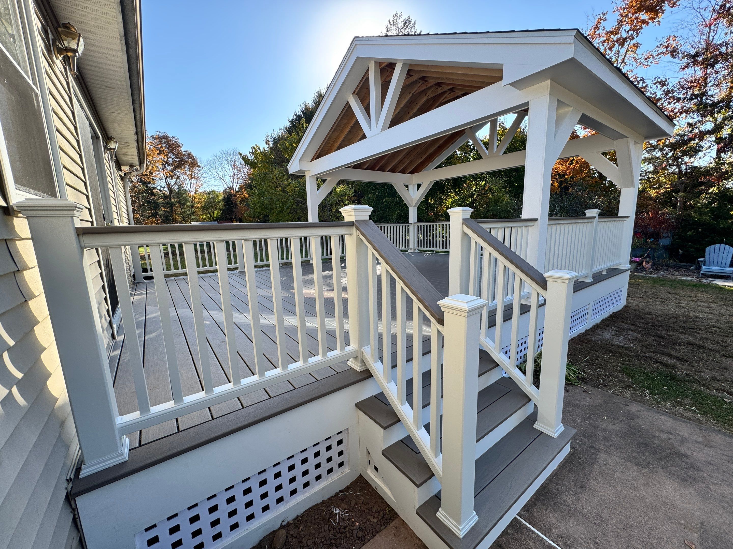 Replacement deck and Roof overhang. Trex Lineage Biscayne boards and matching cocktail rail.  by DiGiorgi Roofing and Siding Inc