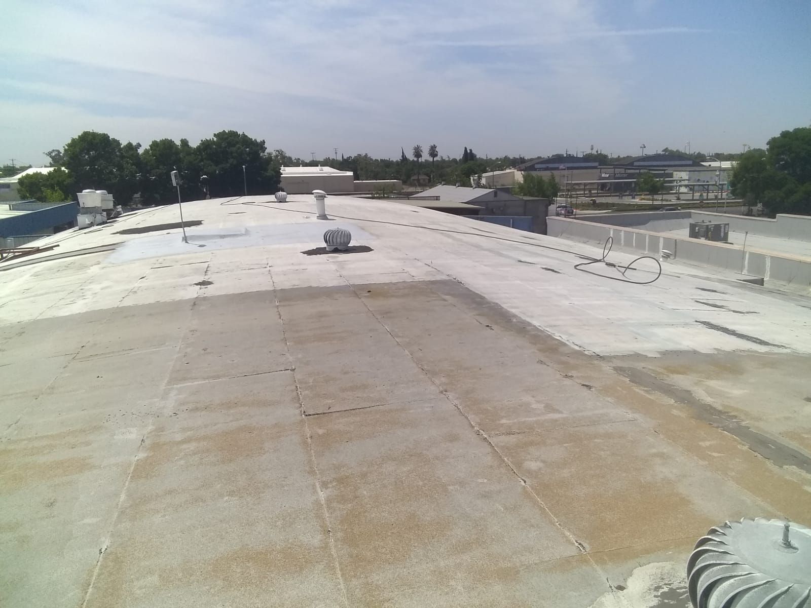 Spray foam and coatings using Conklin Benchmark/PUMA XL coatings and spray foam by Straight Edge Roofing Inc