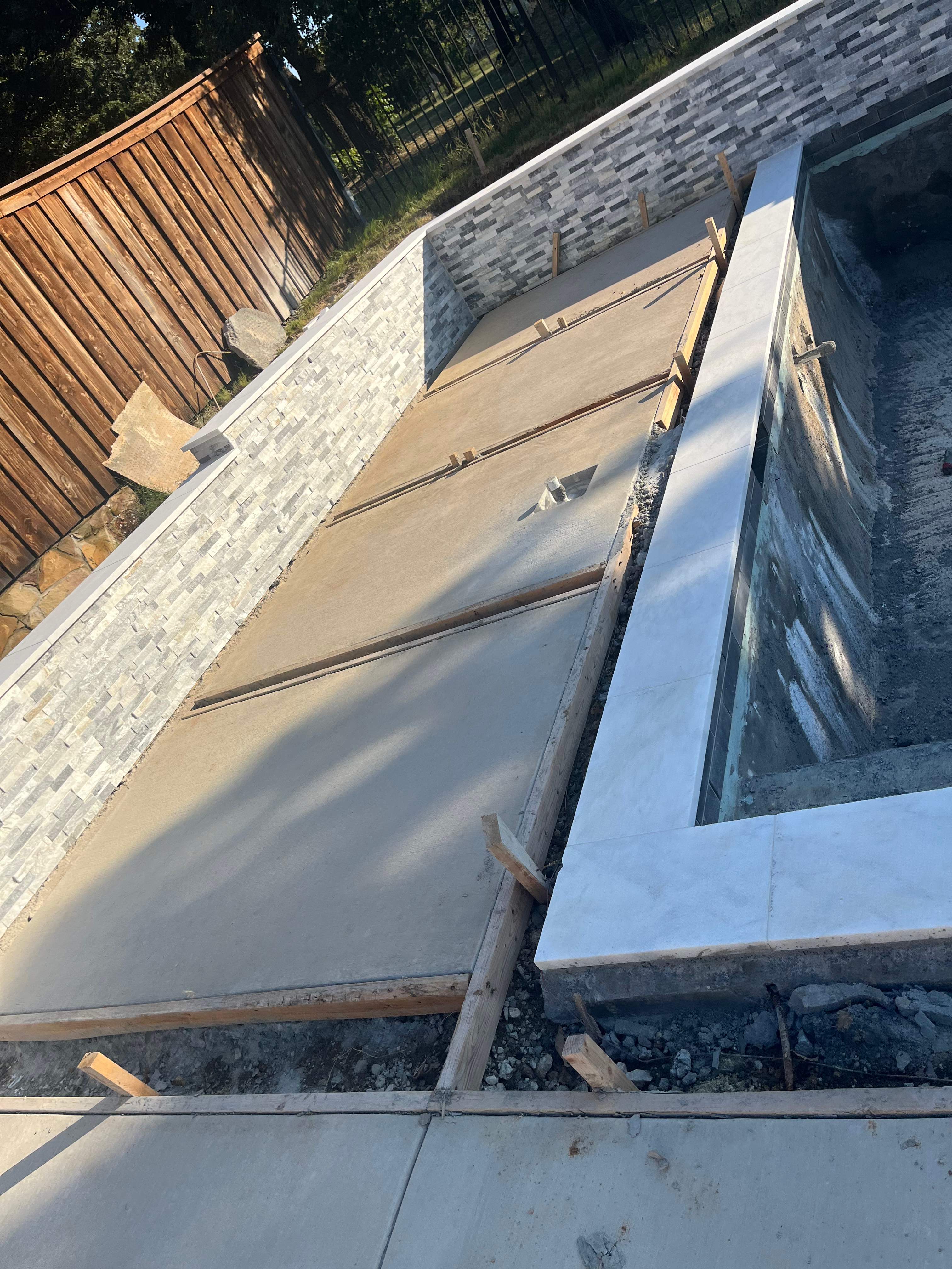 Geometric Pool with Stacked Stone Water Wall by Pinnacle Pools and Spas - DFW