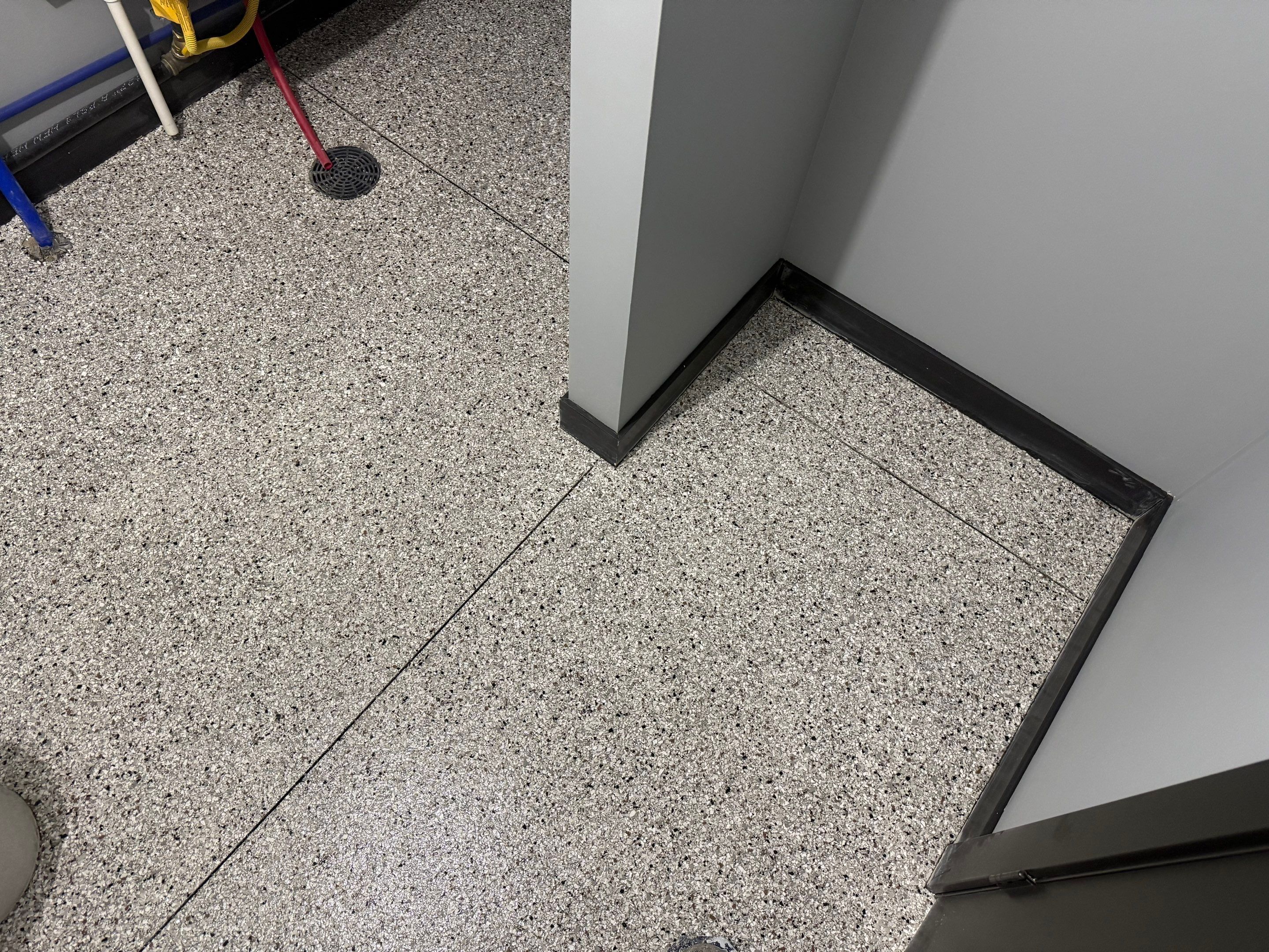 Polyaspartic Garage Floor Coating with Decorative Flake in Wentworth by Select Painting, Coatings & Garage Cabinets
