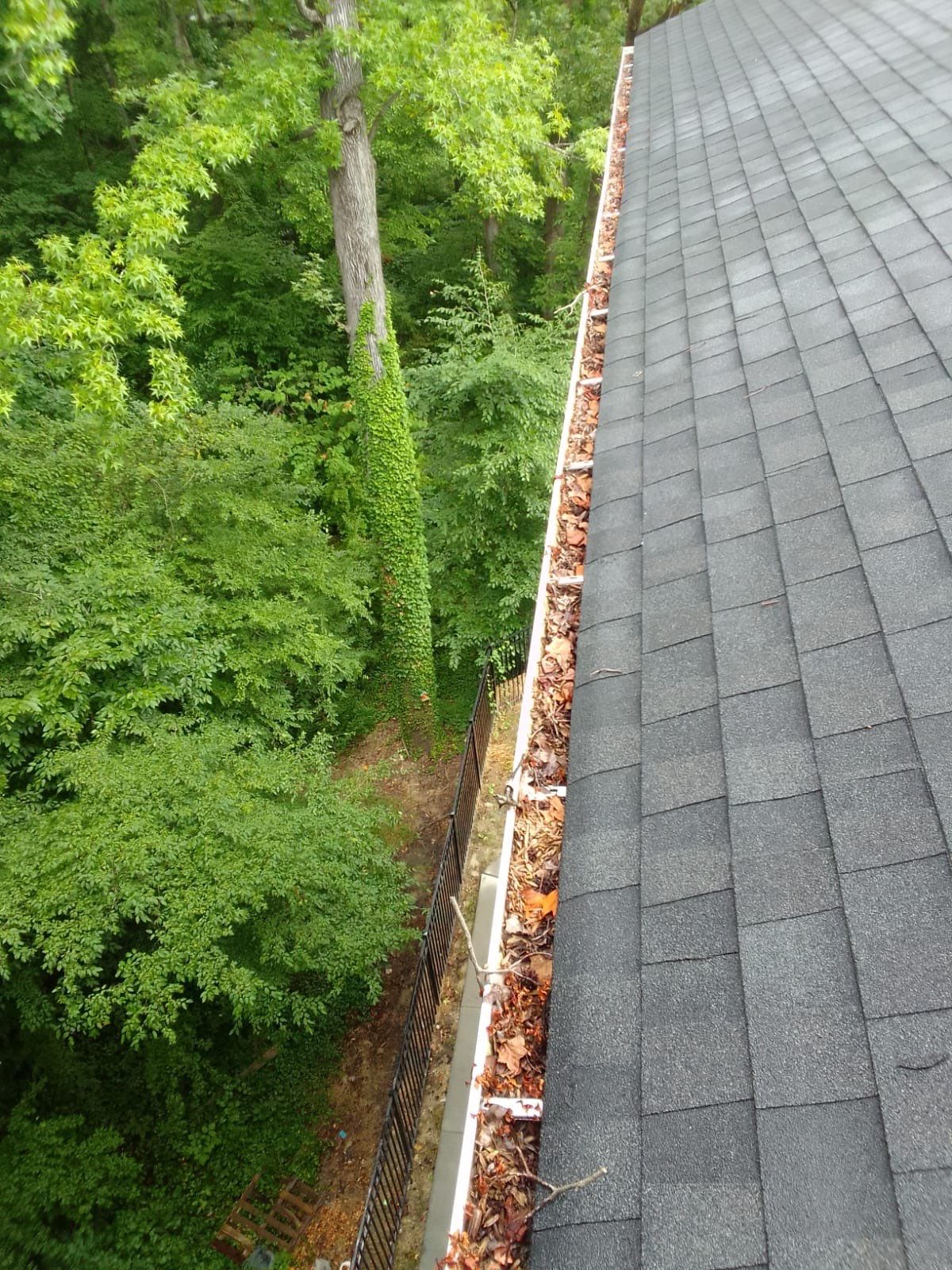 Commercial gutter cleaning Charlotte, NC before photo with filled gutters