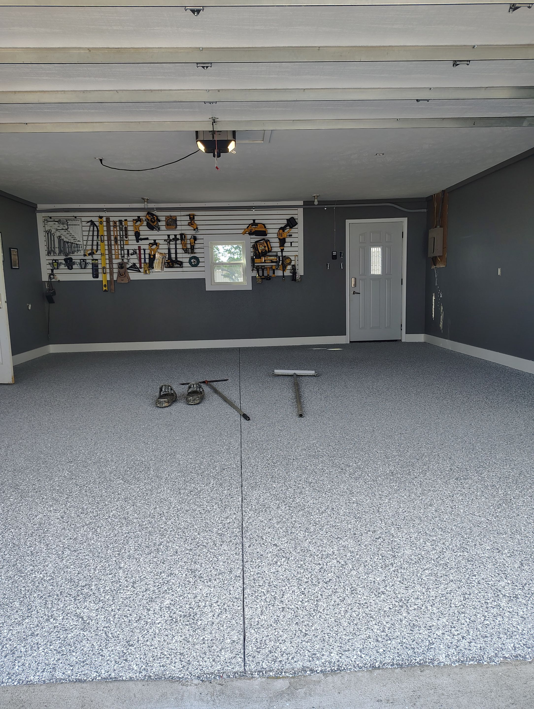 Custom Garage Floor Coating and Backyard Patio Refinishing in Tyndall by Select Painting, Coatings & Garage Cabinets