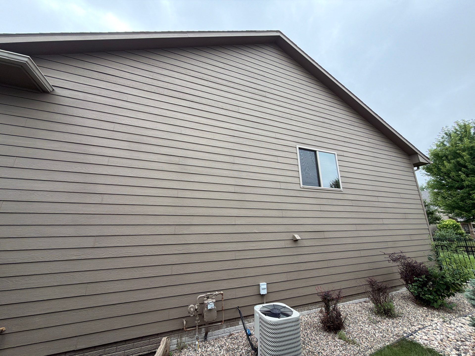 Full Exterior Siding Repaint for Sioux Falls Home and Garage by Select Painting, Coatings & Garage Cabinets