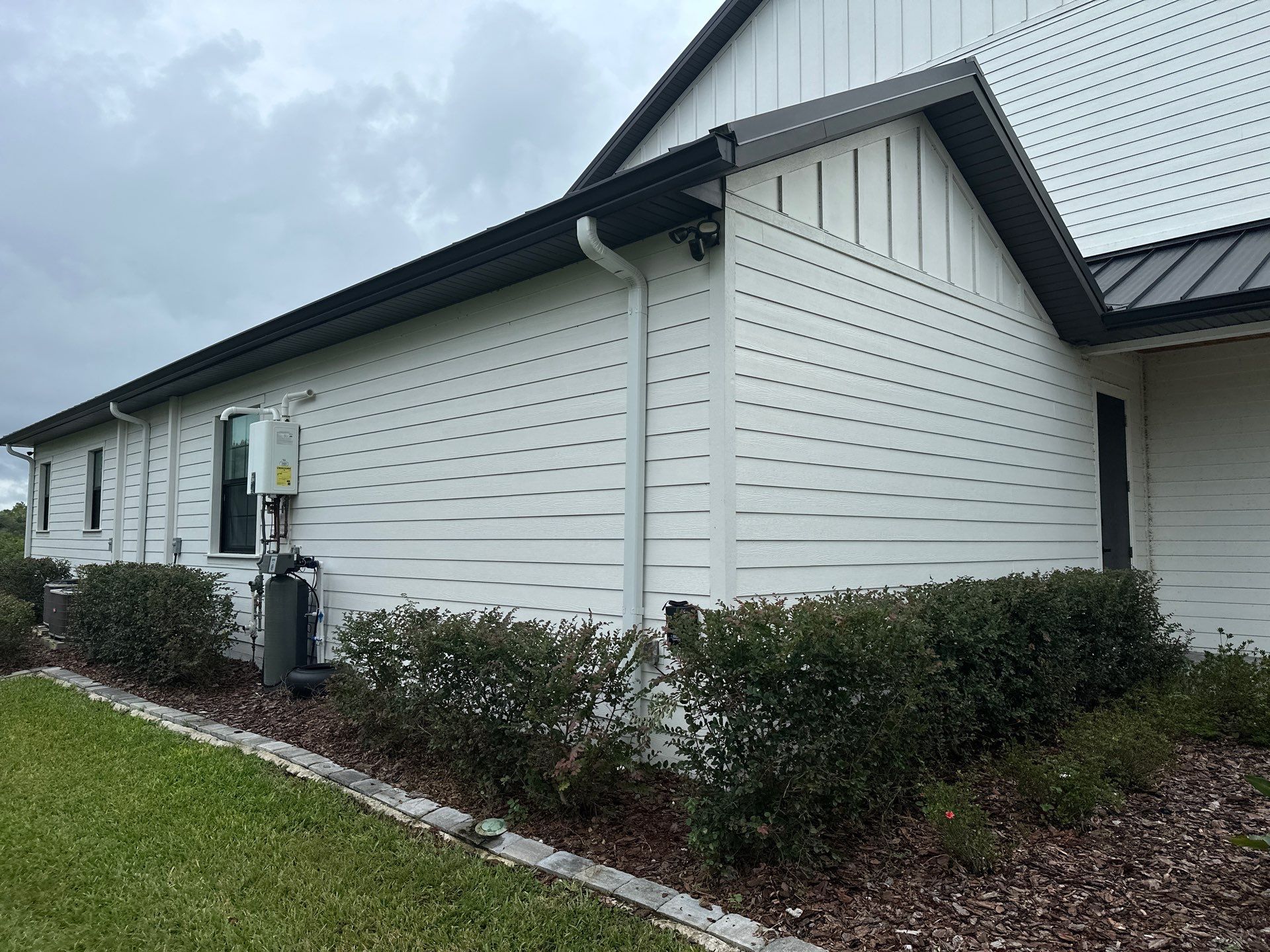 Complete Two-Story House Wash and Driveway Cleaning in Winding River Community, Bradenton, FL by Sunshine AquaWash