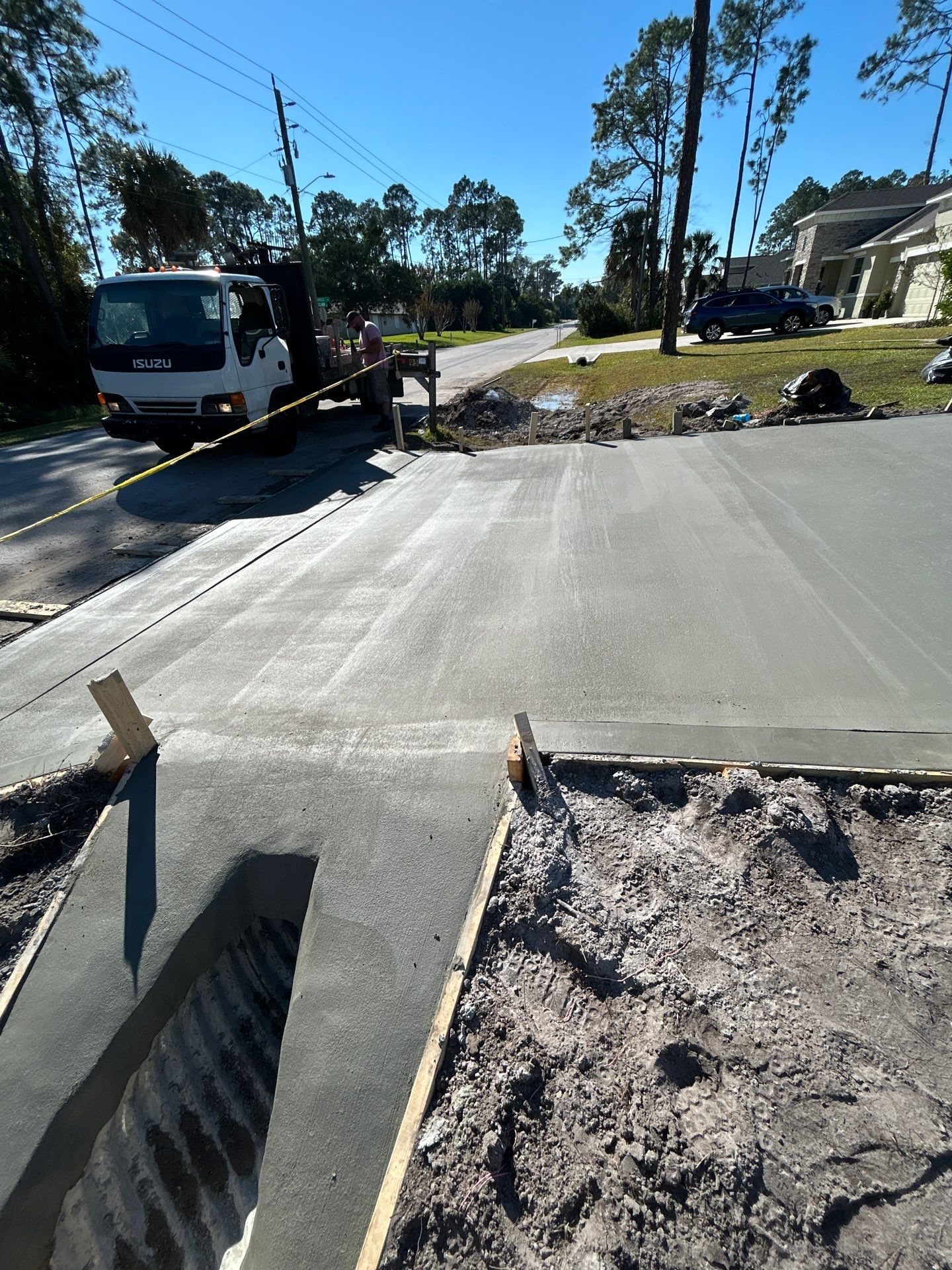 New concrete driveway by Courtesy screening
