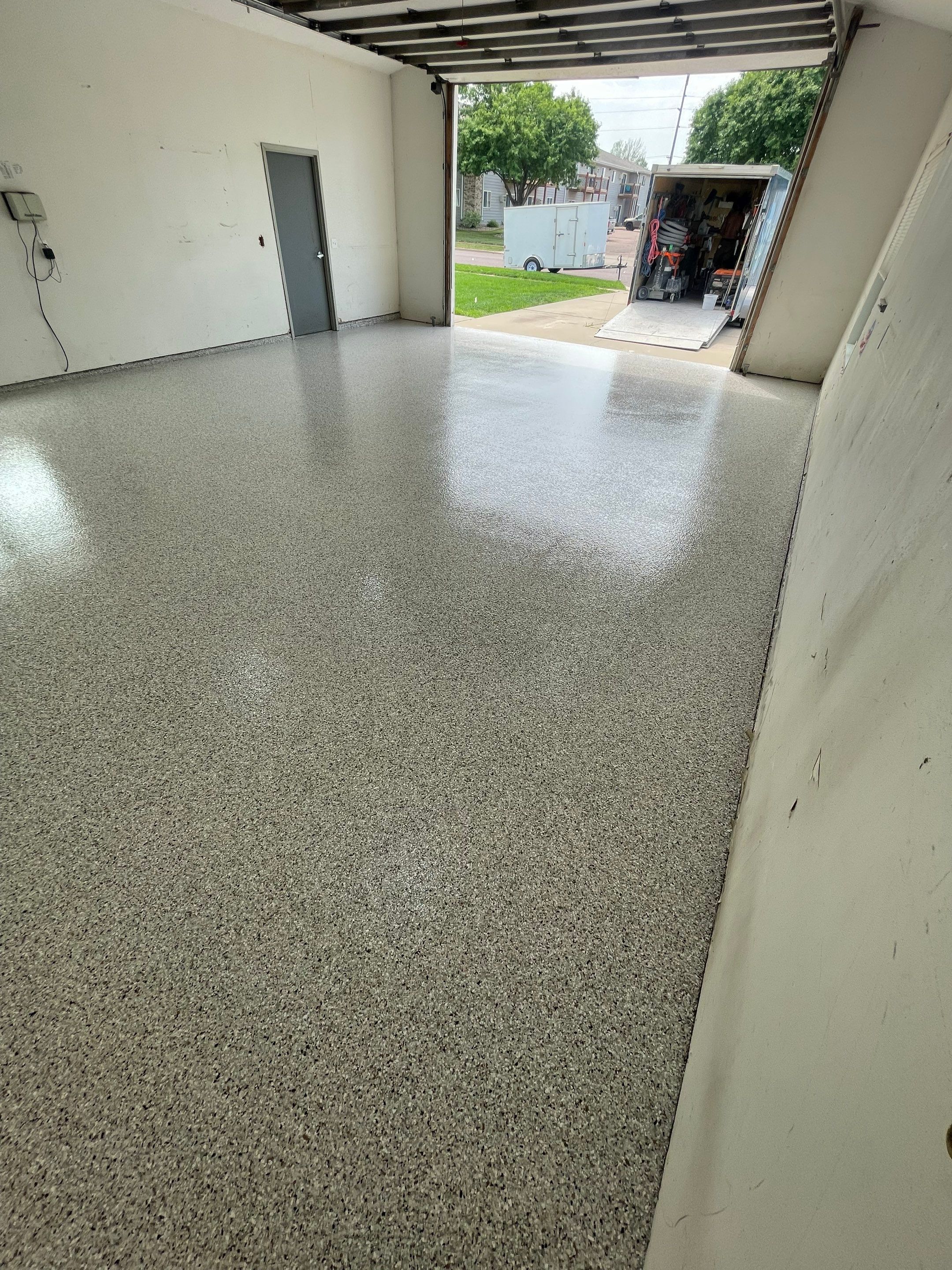 Coyote Flake Concrete Coating for Sioux Falls Garage by Select Painting, Coatings & Garage Cabinets