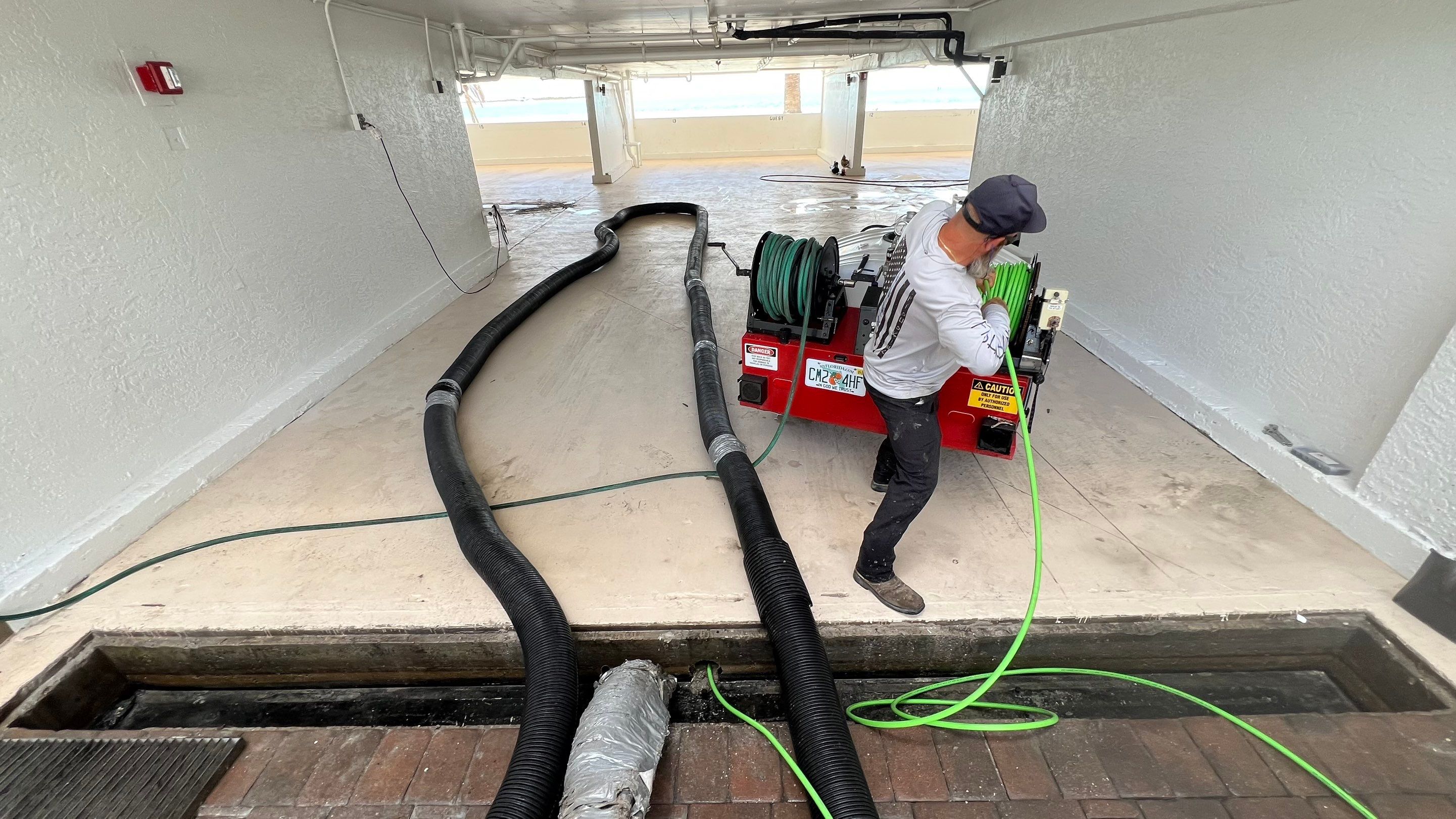 Isles of Capri Condo Parking Garage Drainage System Cleaning by APS Power & Water