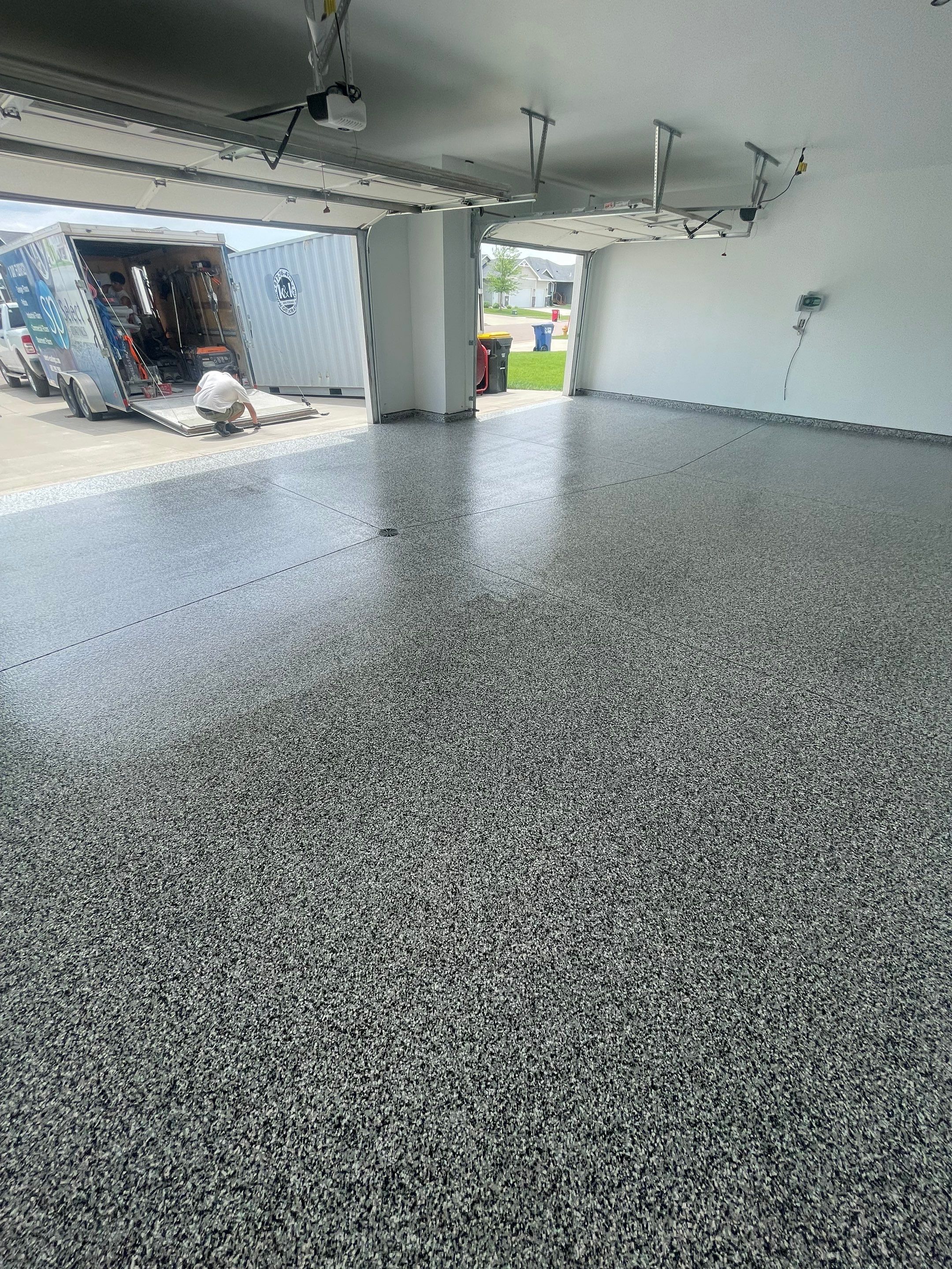 Grey Flake Epoxy Garage Floor Coating in Sioux Falls by Select Painting, Coatings & Garage Cabinets