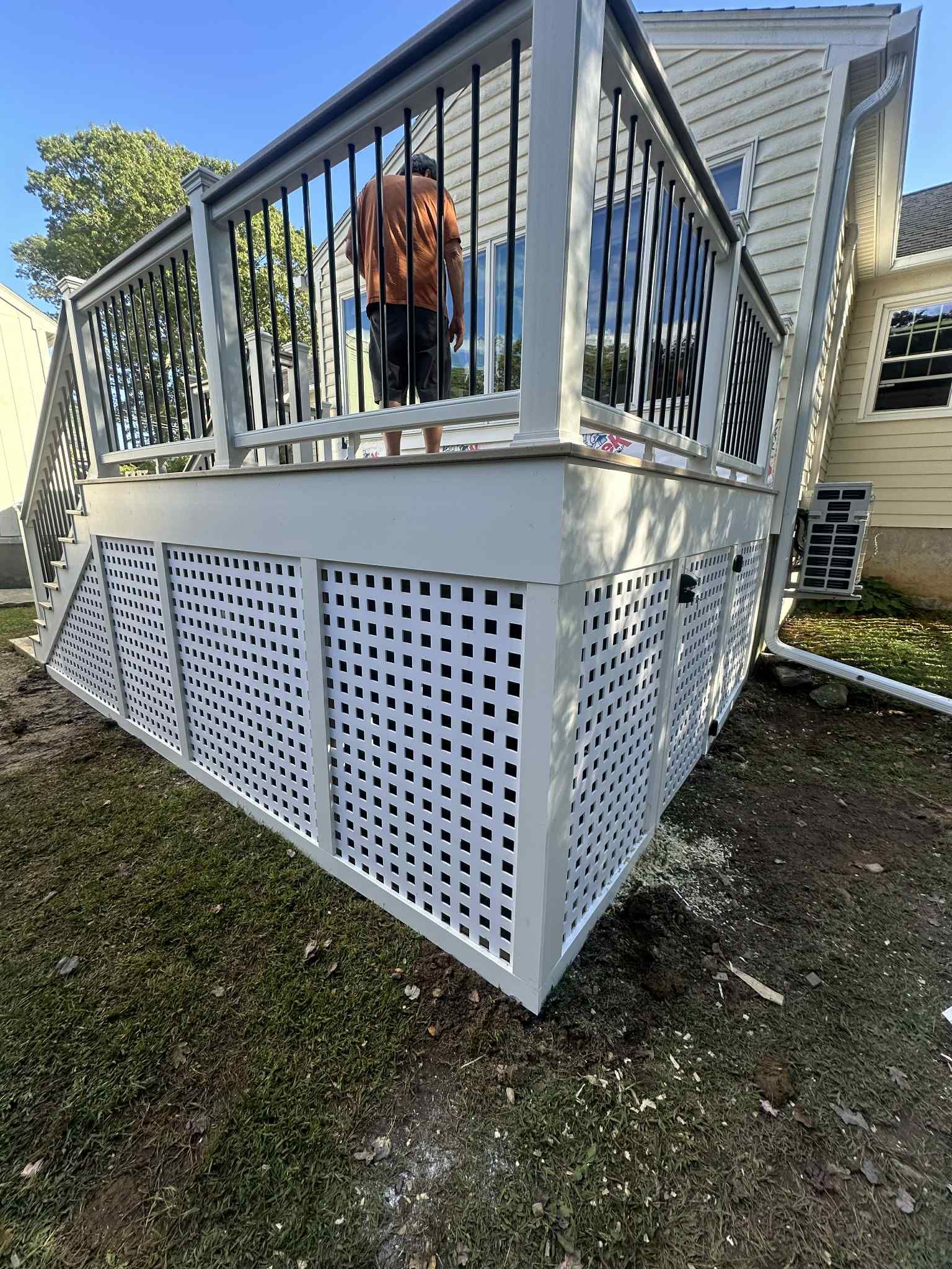 New Deck With Lattice enclosed bottom, Trex Lineage Carmel, Transcend cocktail rail.  by DiGiorgi Roofing and Siding Inc