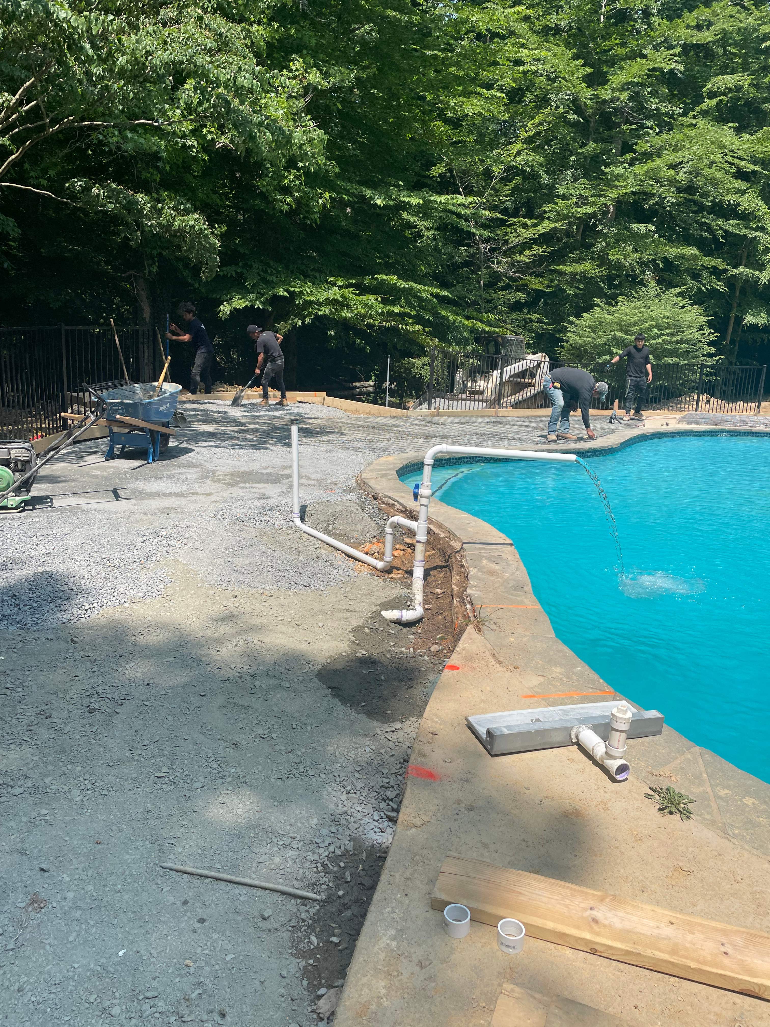 Pool Surround remodel with retaining walls, new waterfall and water slide by Fairfax Contractors, LLC