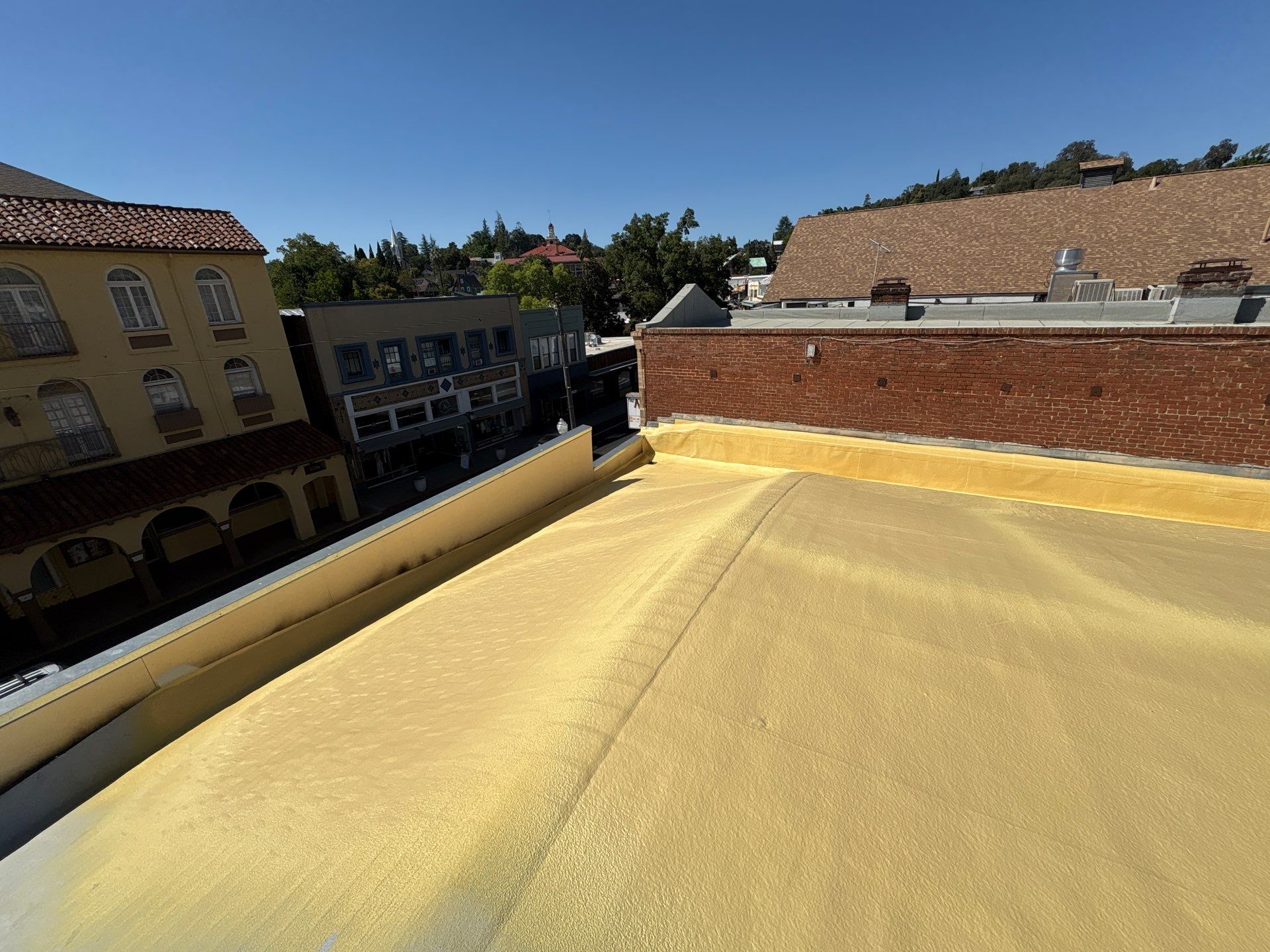 Foam and coatings on commercial roof by Straight Edge Roofing Inc