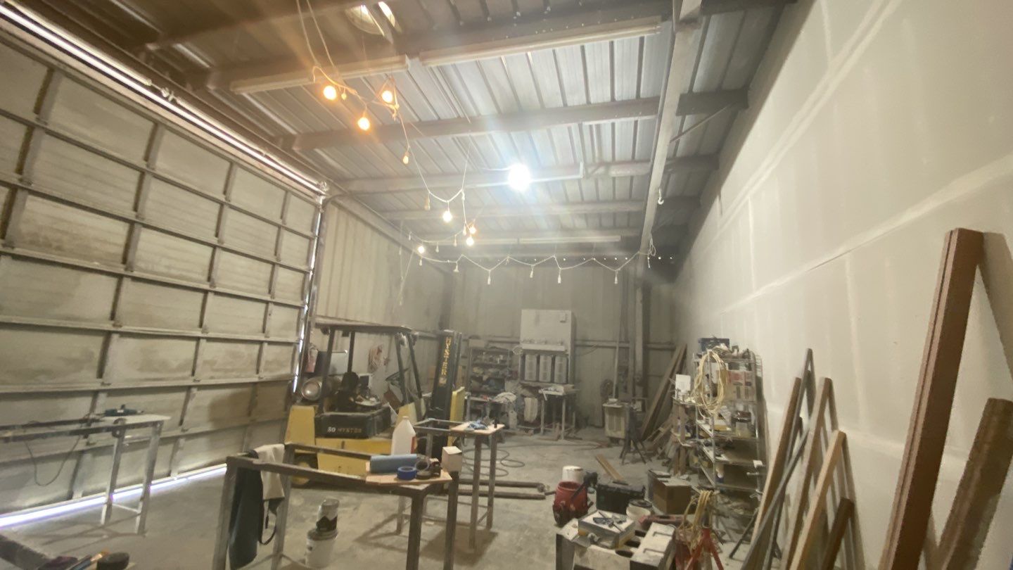 Spray foam insulation on inside of metal industrial building by Straight Edge Roofing Inc