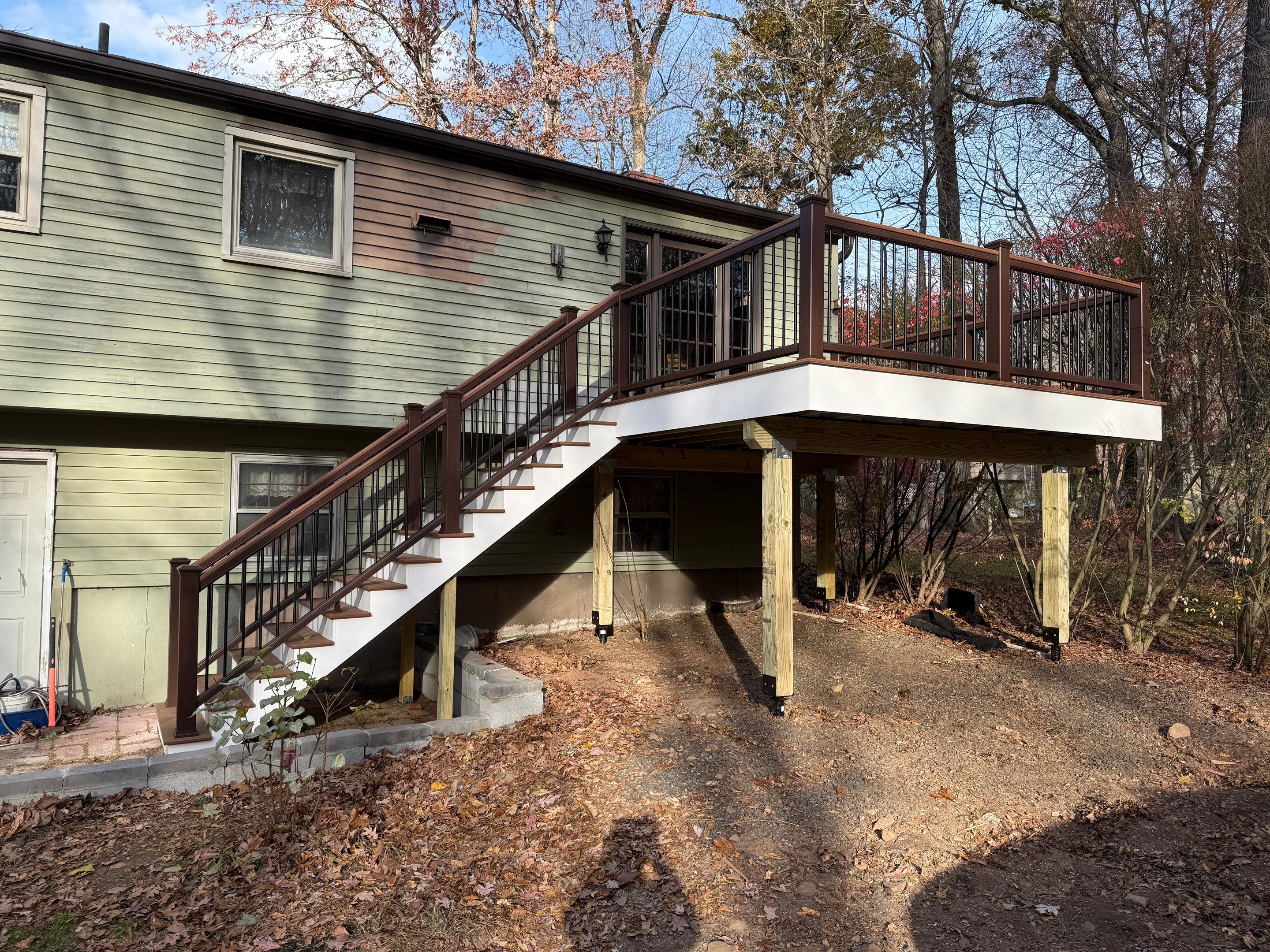 Replacement deck with Trex Tropical Tiki torch and Transcend Cocktail railings in vintage lantern. by DiGiorgi Roofing and Siding Inc