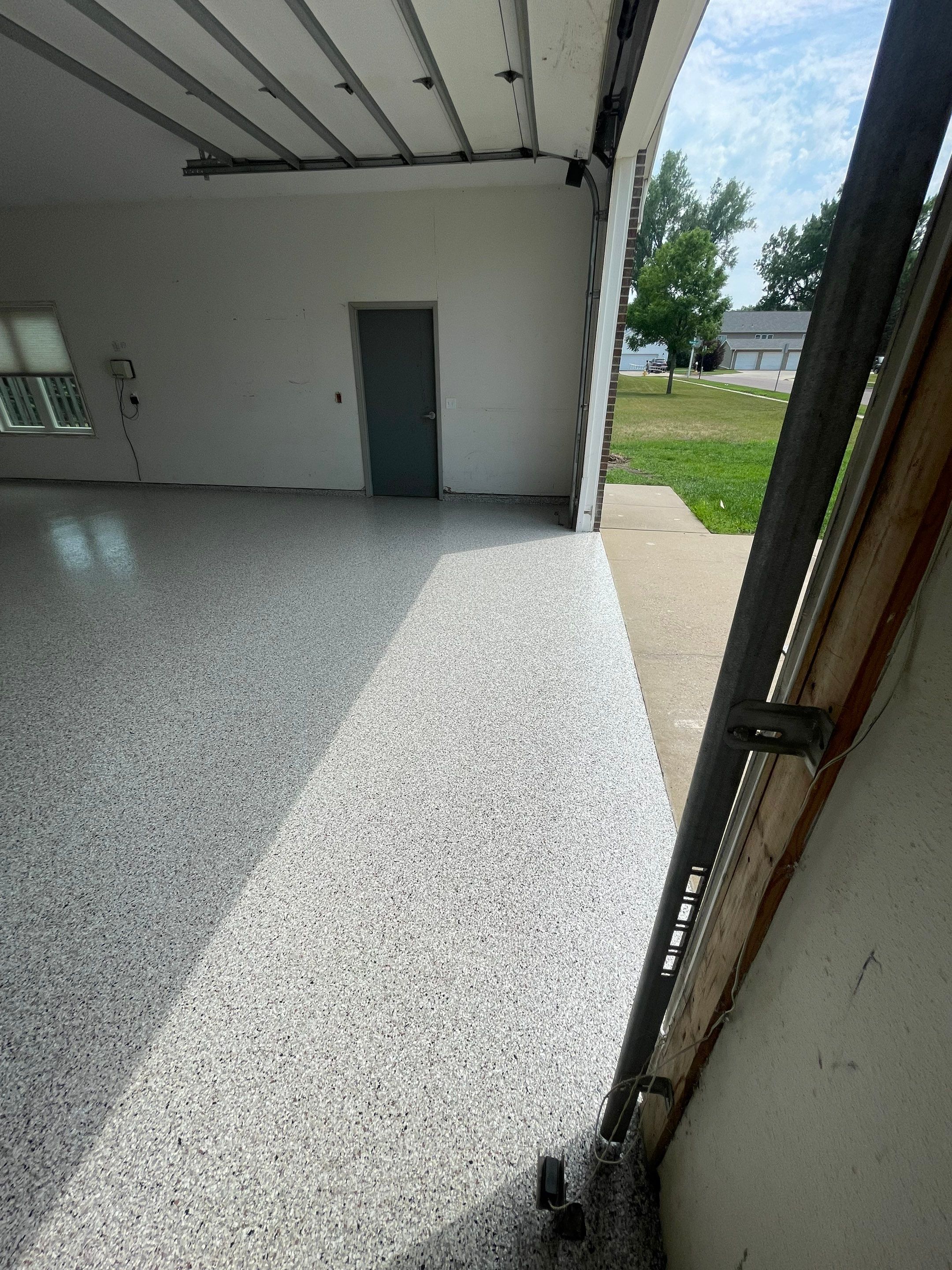 Coyote Flake Concrete Coating for Sioux Falls Garage by Select Painting, Coatings & Garage Cabinets