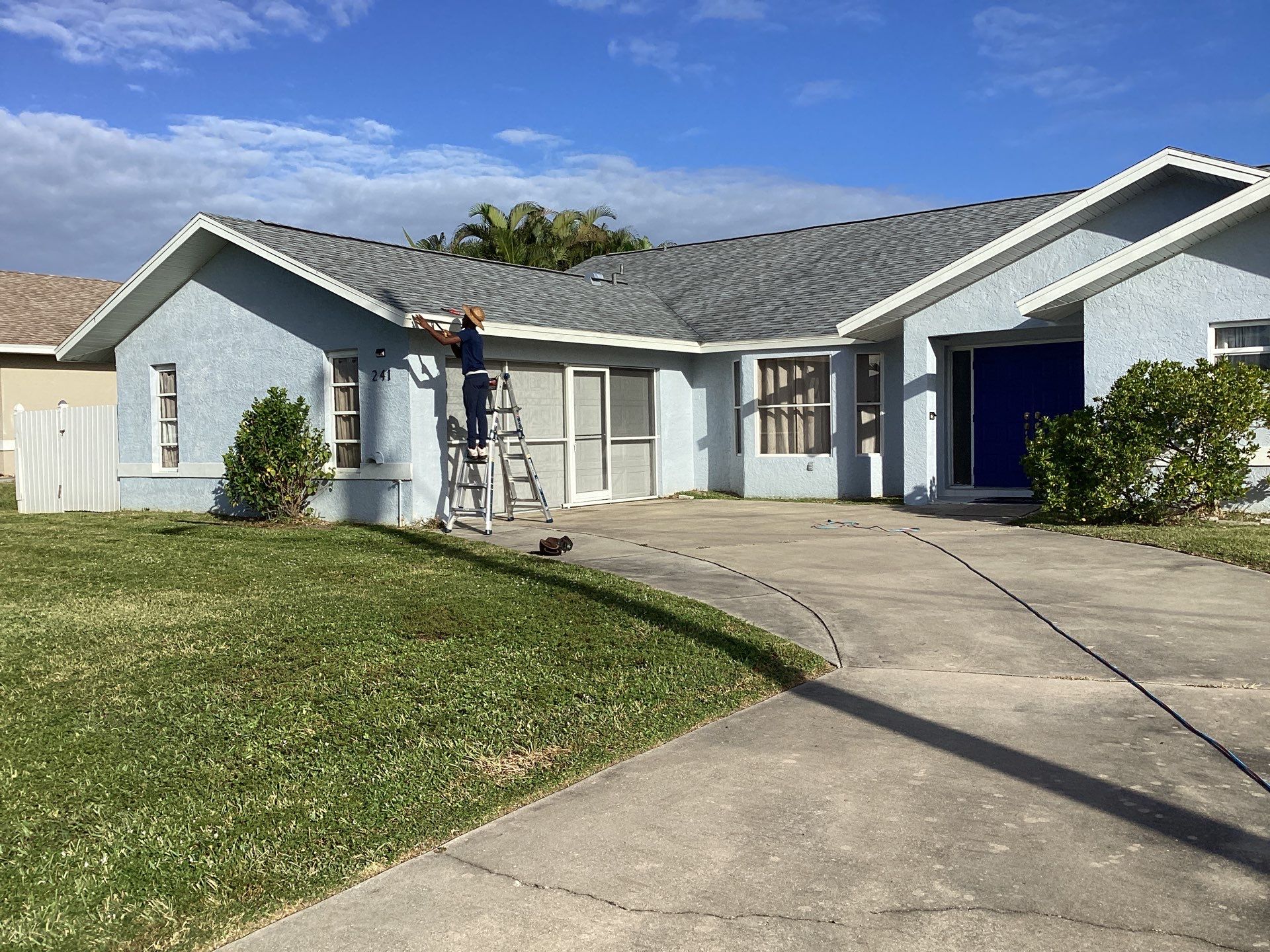 New White Seamless Gutters with Downspouts and Splash Guards in Cape Coral FL by Gutter Professors