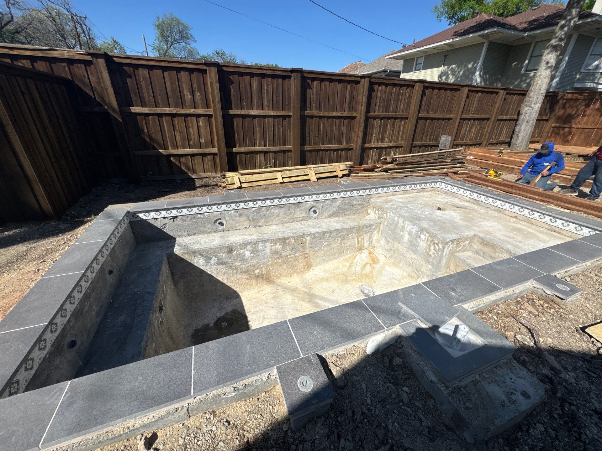 Modern Plunge Pool with Dark Interior and Paver Patio by Pinnacle Pools and Spas - DFW