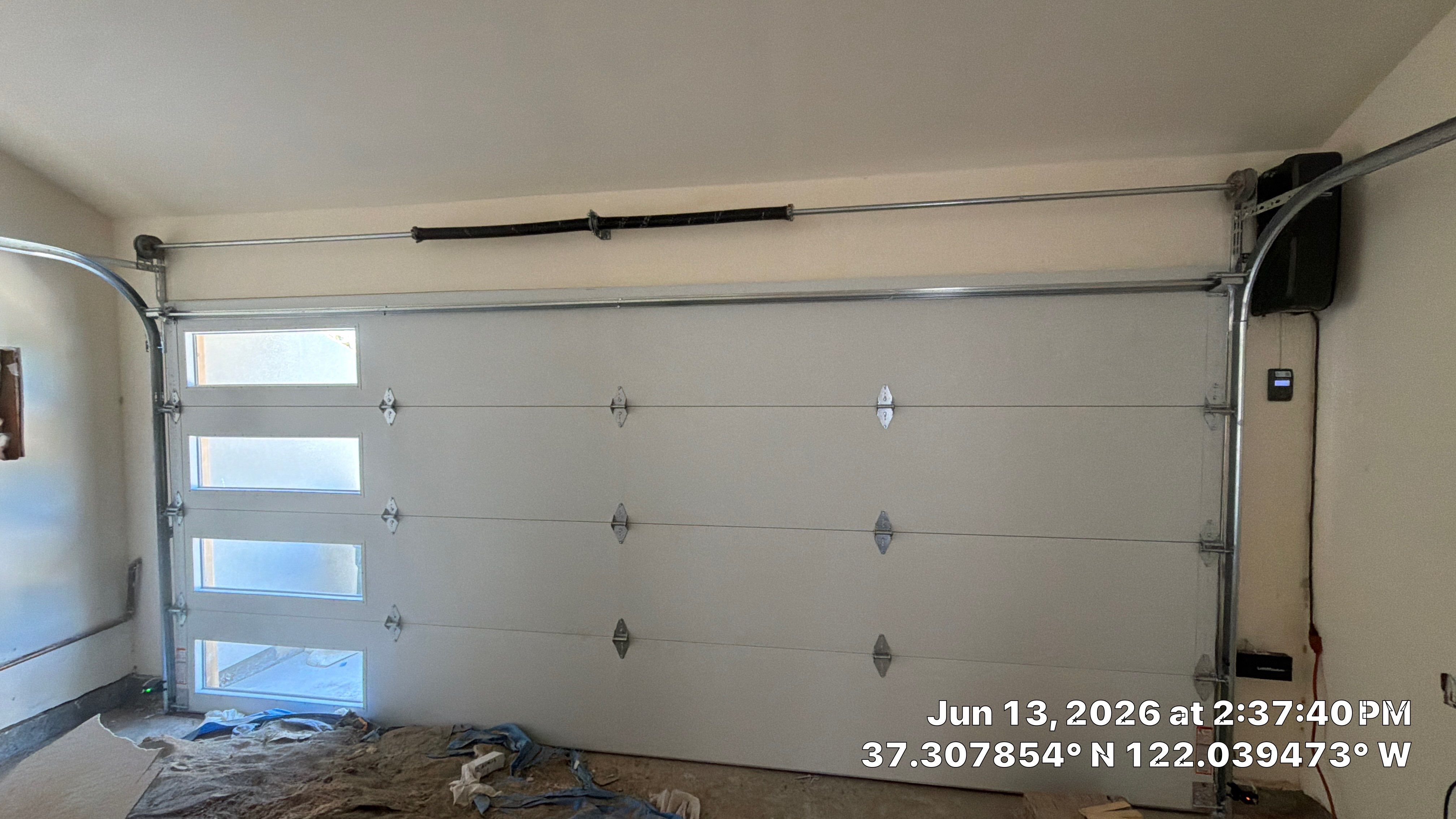 Modern Black Garage Door Installation With Vertical Windows In Cupertino by Valiant Garage Door LLC
