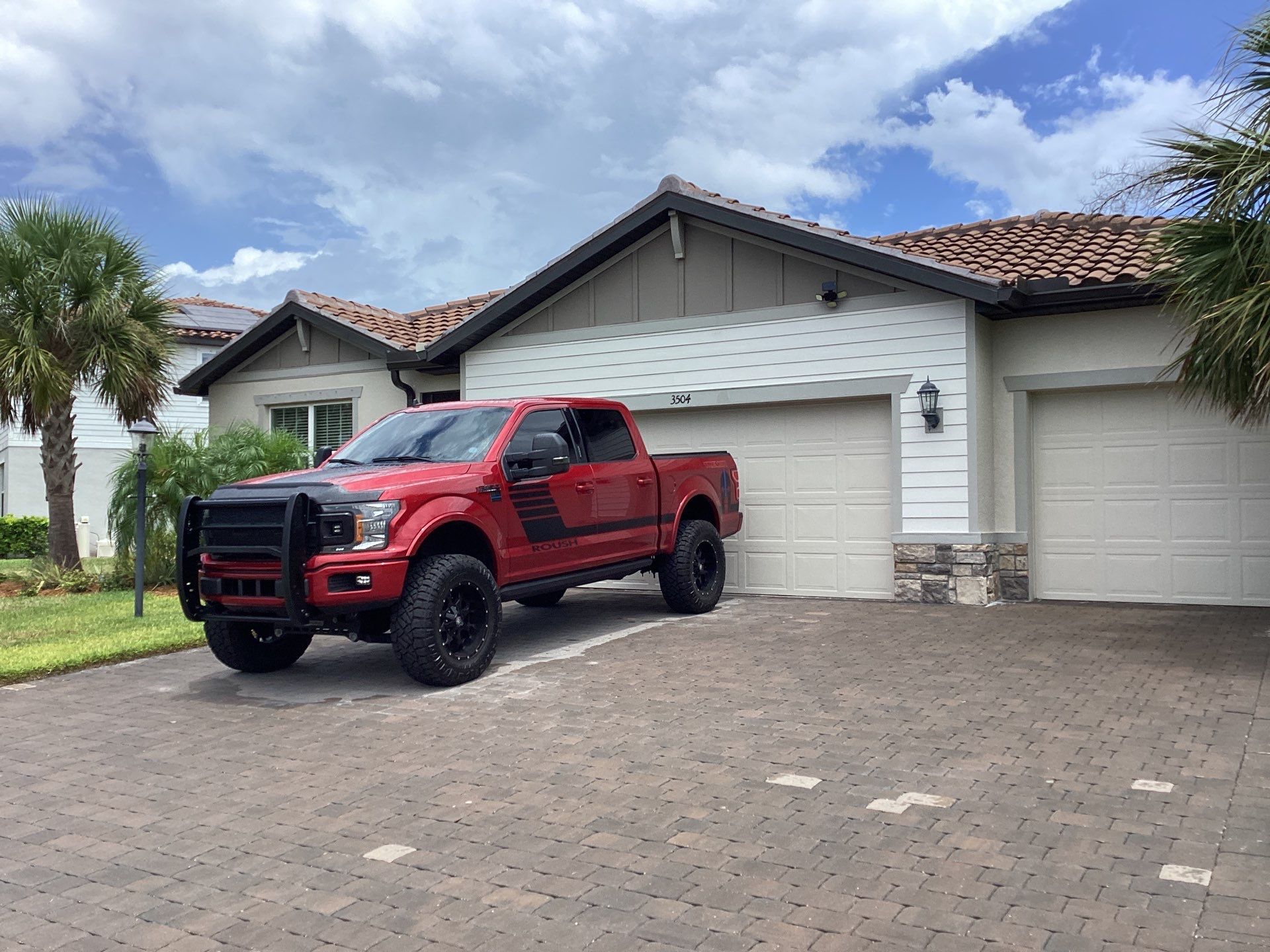 Musket brown seamless gutters with splash guards, new downspouts, and extensions in Bradenton, FL by Gutter Professors