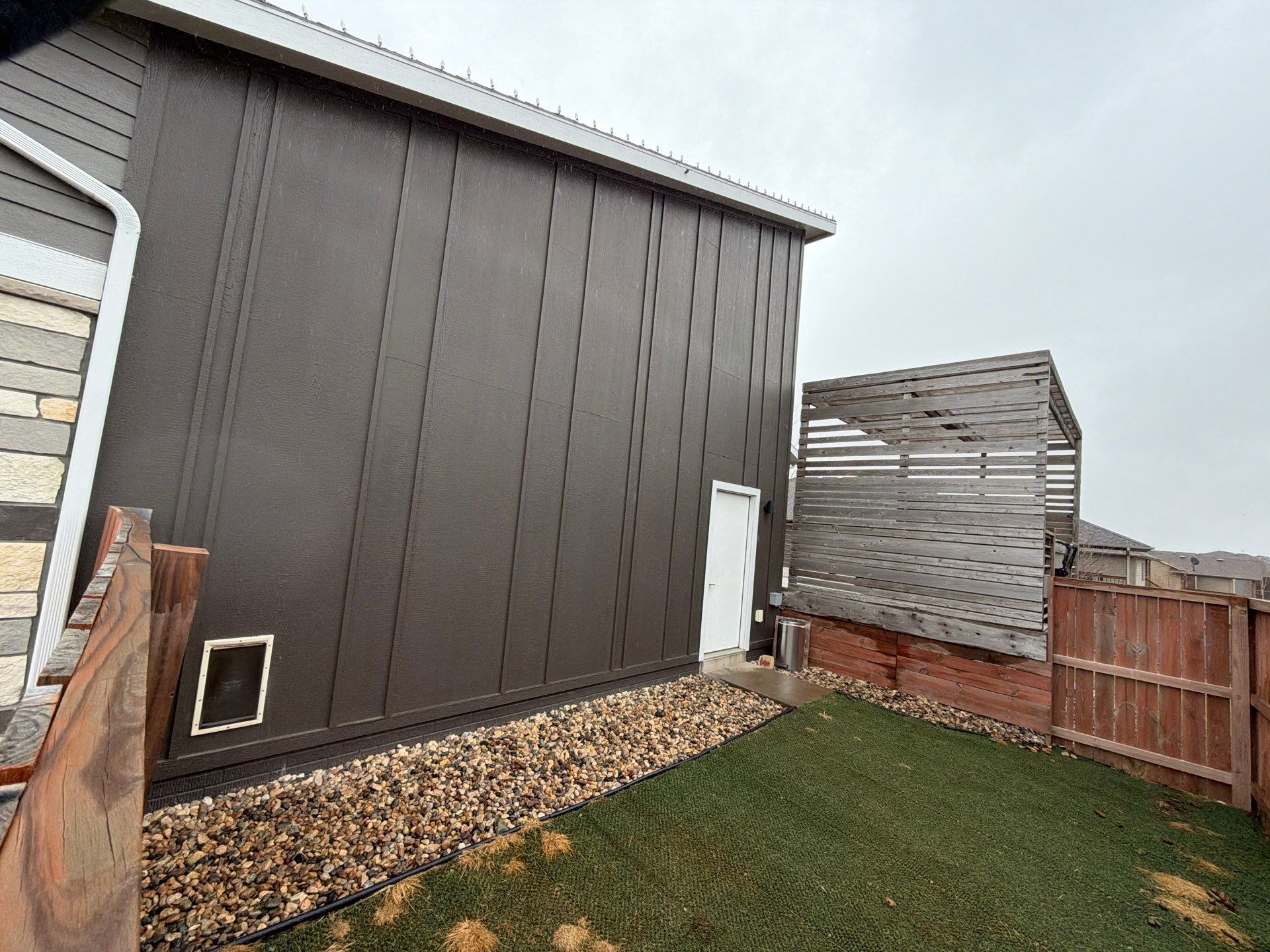 Modern Exterior Transformation Featuring Dark Board and Batten Siding in Sioux Falls by Select Painting, Coatings & Garage Cabinets