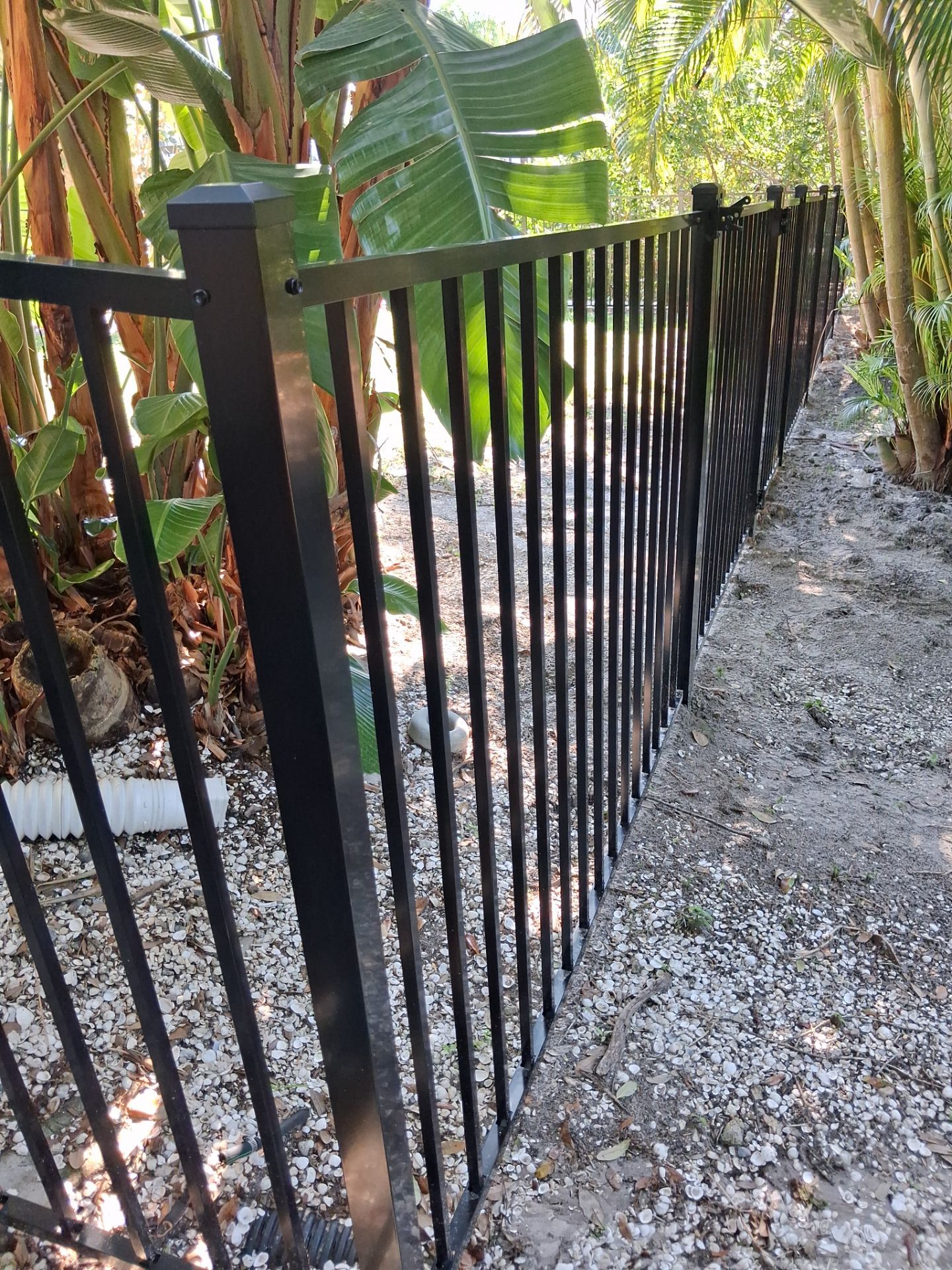 Black Aluminum Picket Fence Installation for Port Charlotte Canal Home by True Fence LLC