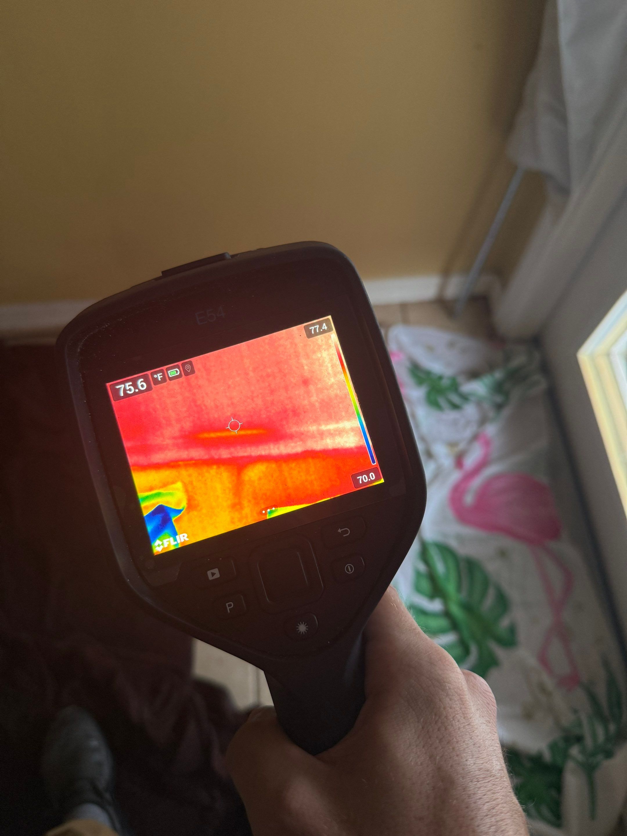 Restoration technician using thermal imaging camera