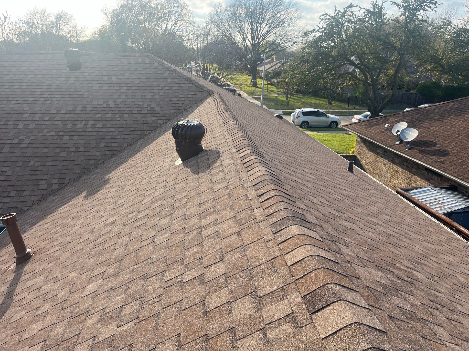 Medium brown brick with Tamko Rustic Cedar by Tejas Roofworks + Restoration