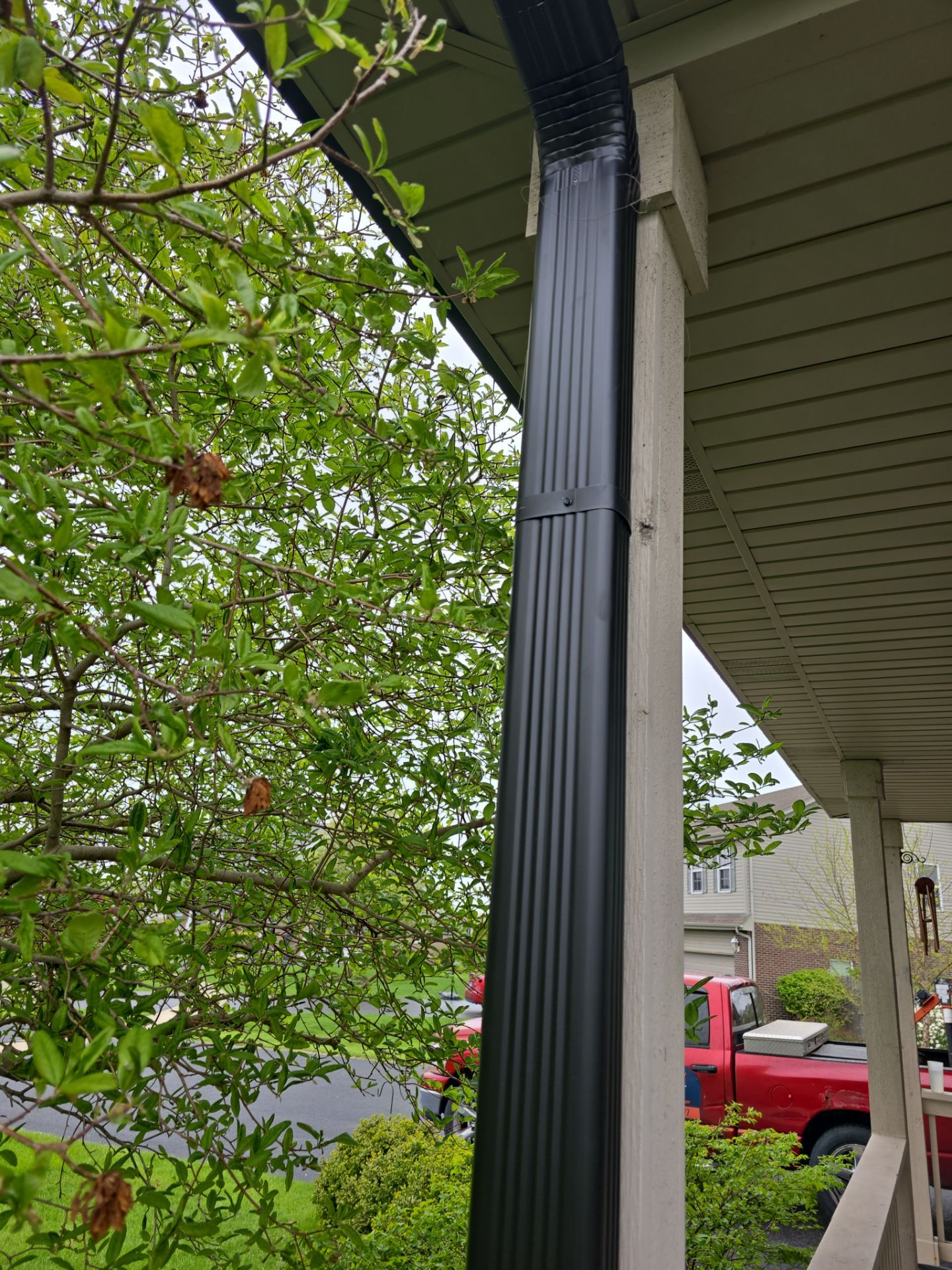 New black gutters and roof by Optimal Home Improvement 